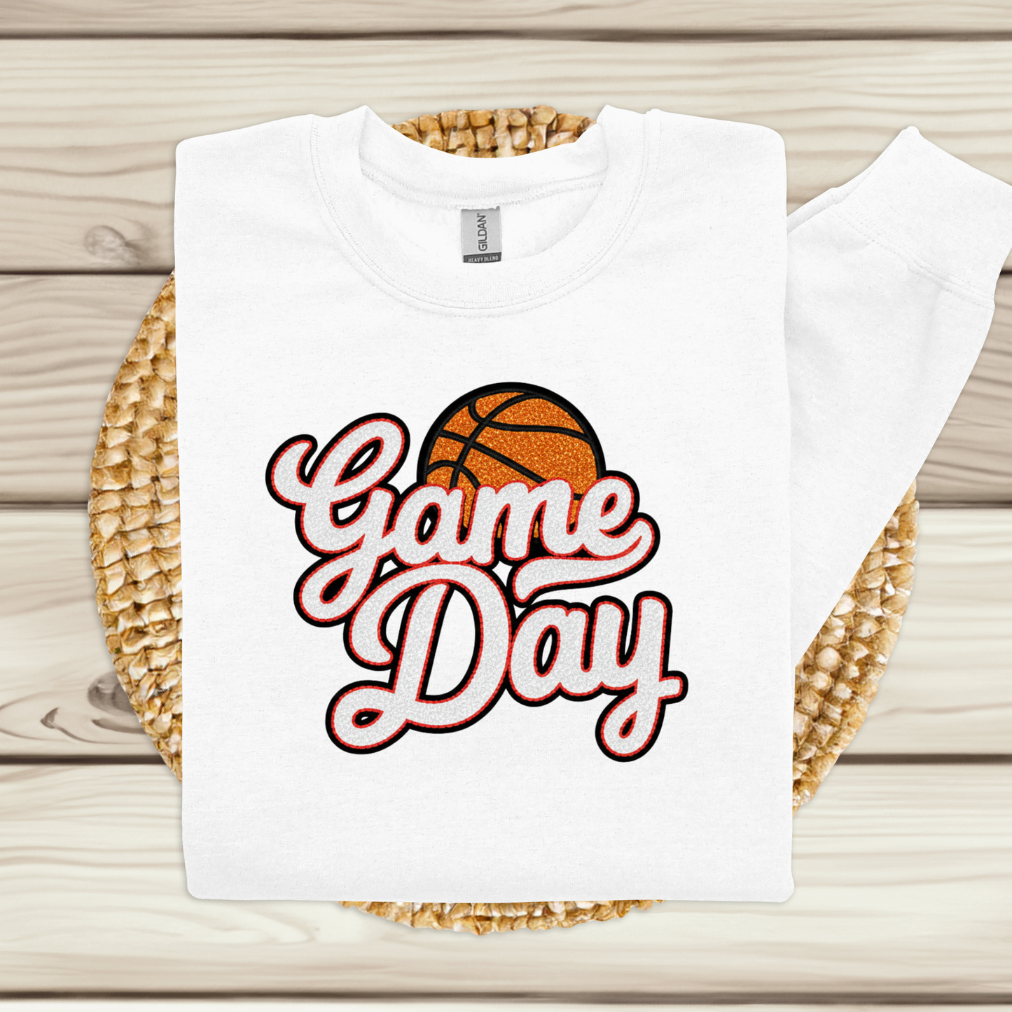 White t-shirt with 'Game Day' and basketball graphic on a woven mat