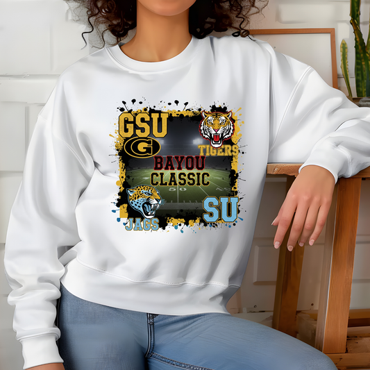 Person wearing a white sweatshirt with sports team graphics and text.  Bayou Classic Football Sweater - Grambling State GSU Tigers vs. Southern University SU Jags Sweater