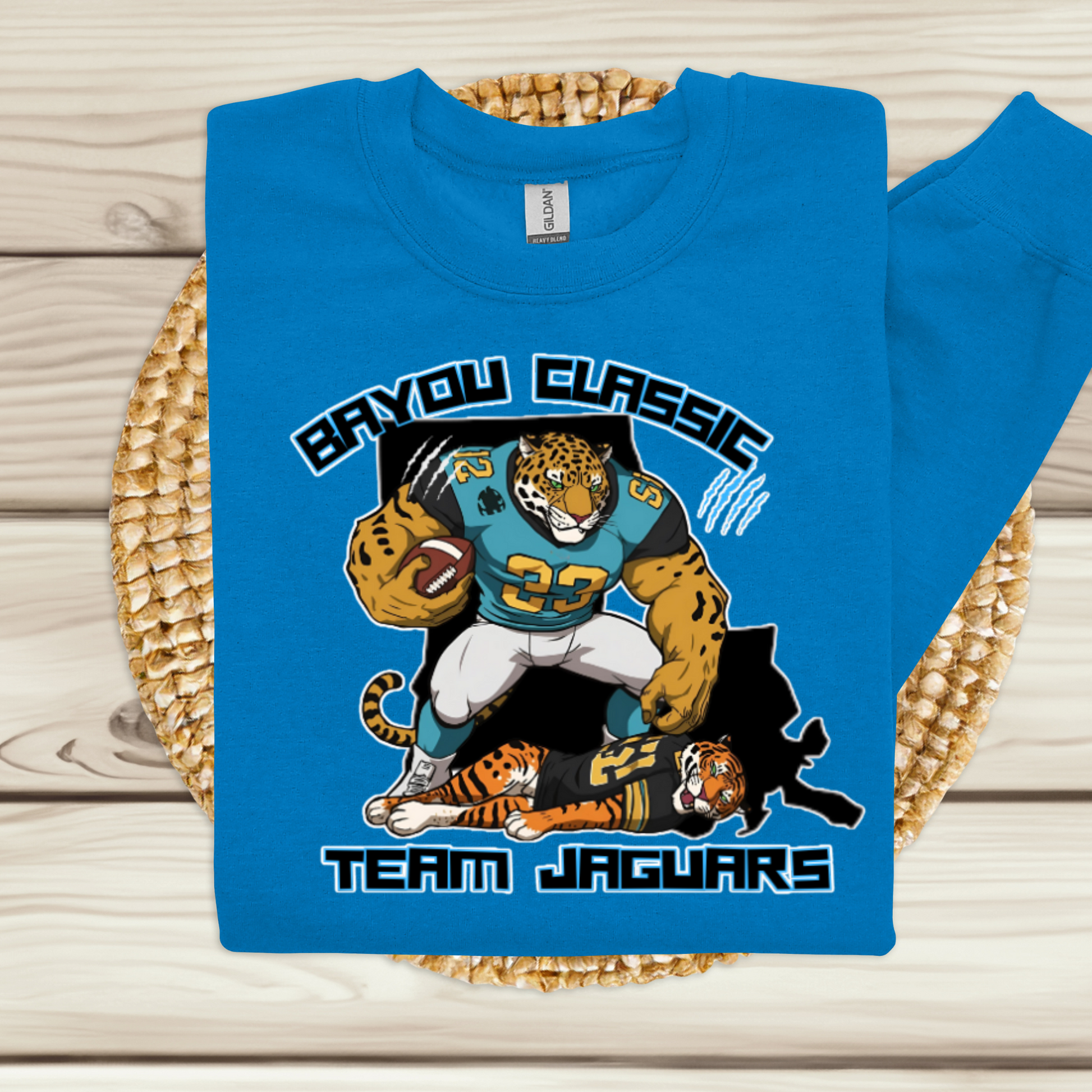 Blue t-shirt with a Jaguar-themed design on a woven surface  Bayou Classic Team Jaguars: Bayou Classic HBCU Jaguars Game Day Sweater