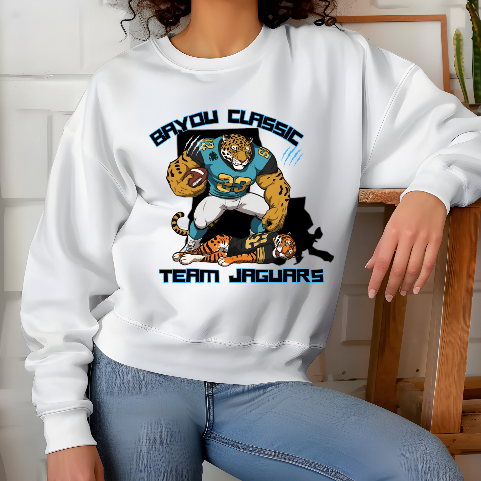 Person wearing a white sweatshirt with 'Bayou Classic Team Jaguars' design.  Bayou Classic Team Jaguars: Bayou Classic HBCU Jaguars Game Day Sweater