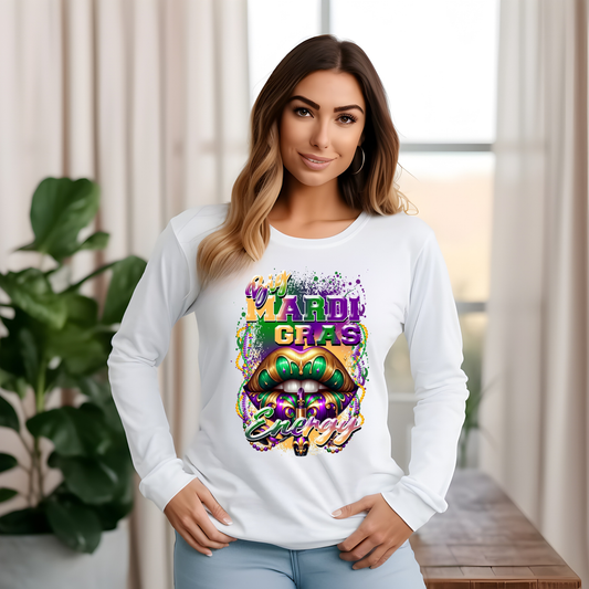 Woman wearing a white long-sleeve shirt with Mardi Gras-themed design indoors.