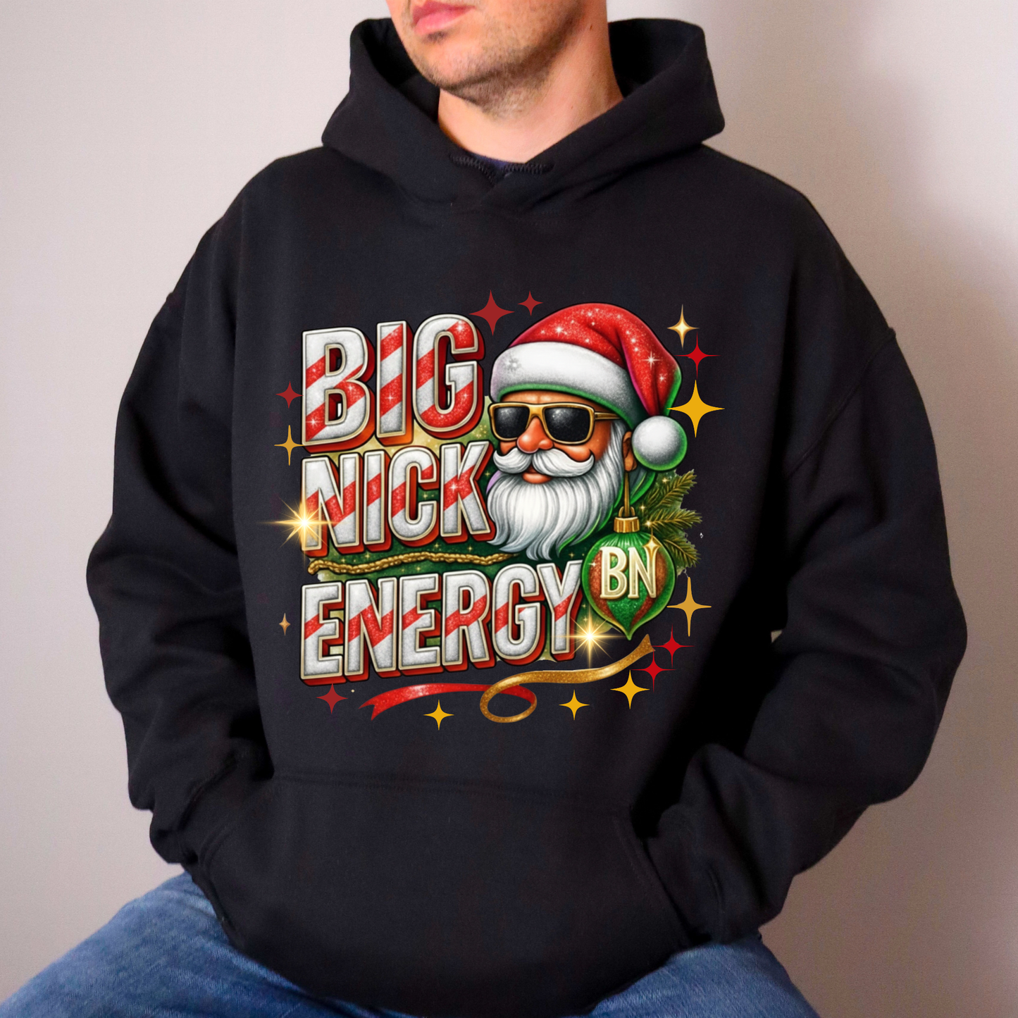 Person wearing a black hoodie with a colorful graphic design featuring a Santa Claus-like character and text.