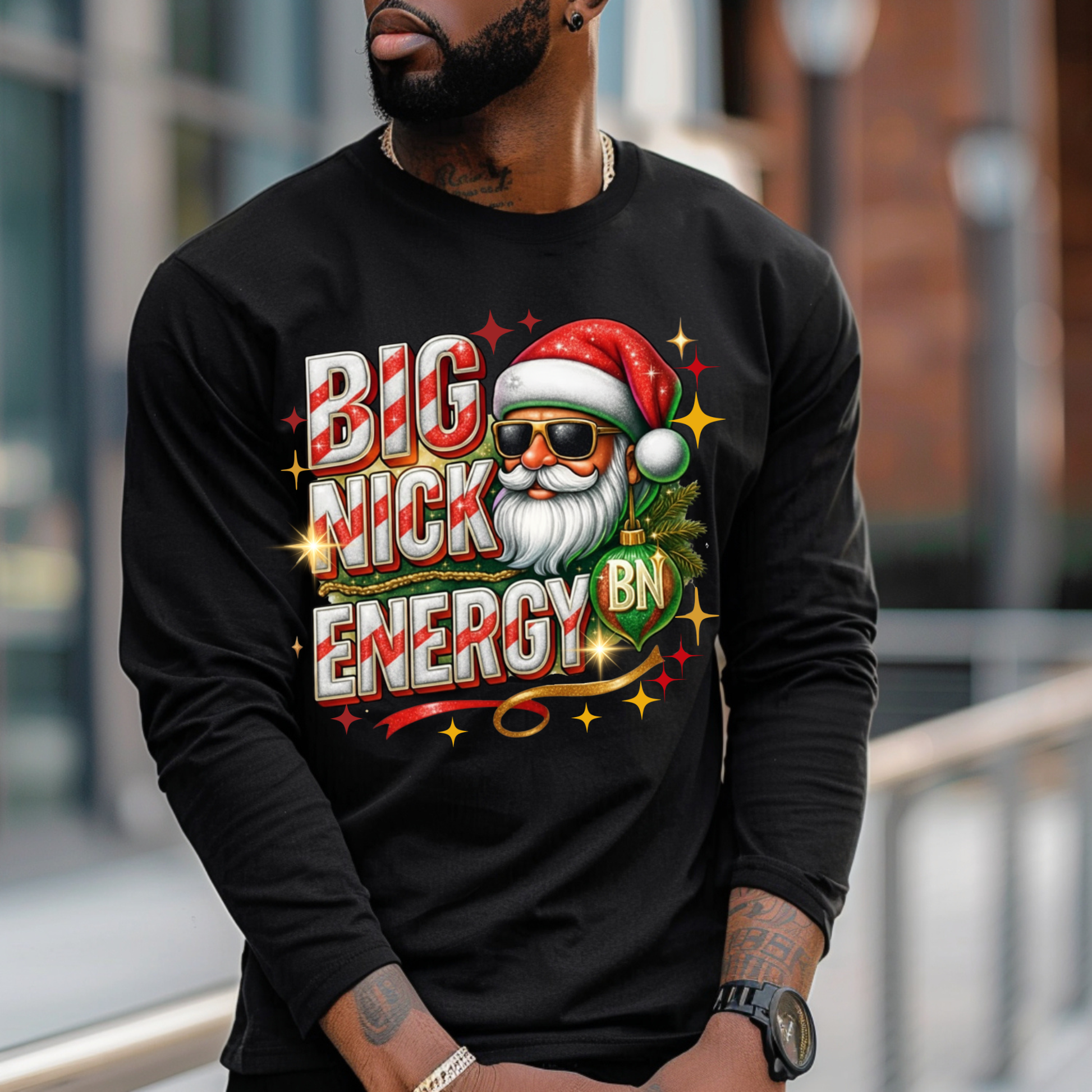 Person wearing a black long-sleeve shirt with a colorful graphic design featuring a Santa Claus-like character and text.