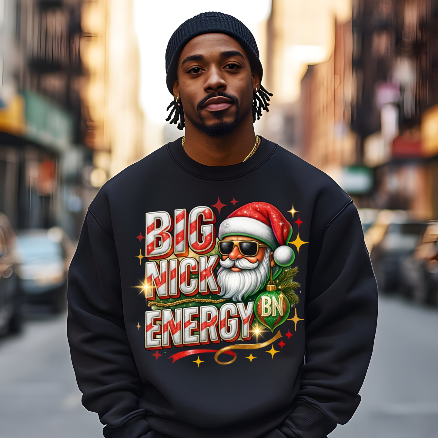 Man wearing a black sweatshirt with a colorful graphic and text on a city street.