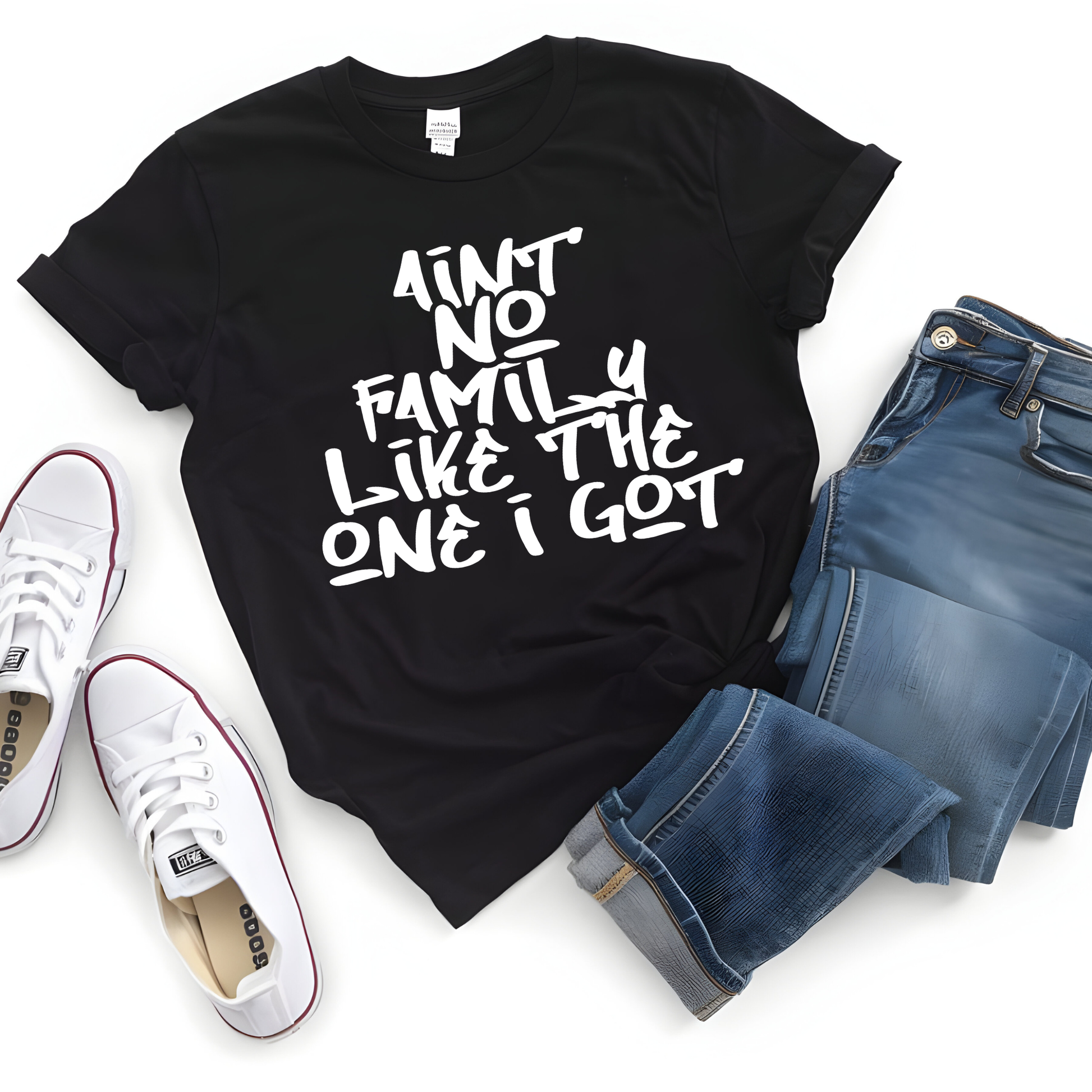 Black t-shirt with text, white sneakers, and blue jeans on a white background