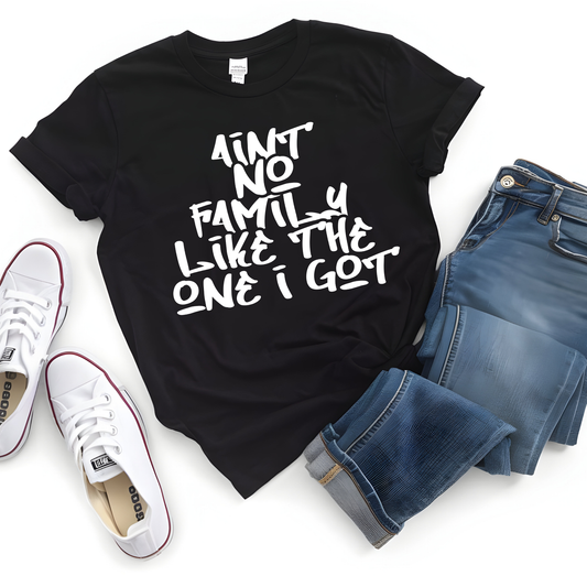 Black t-shirt with text, white sneakers, and blue jeans on a white background