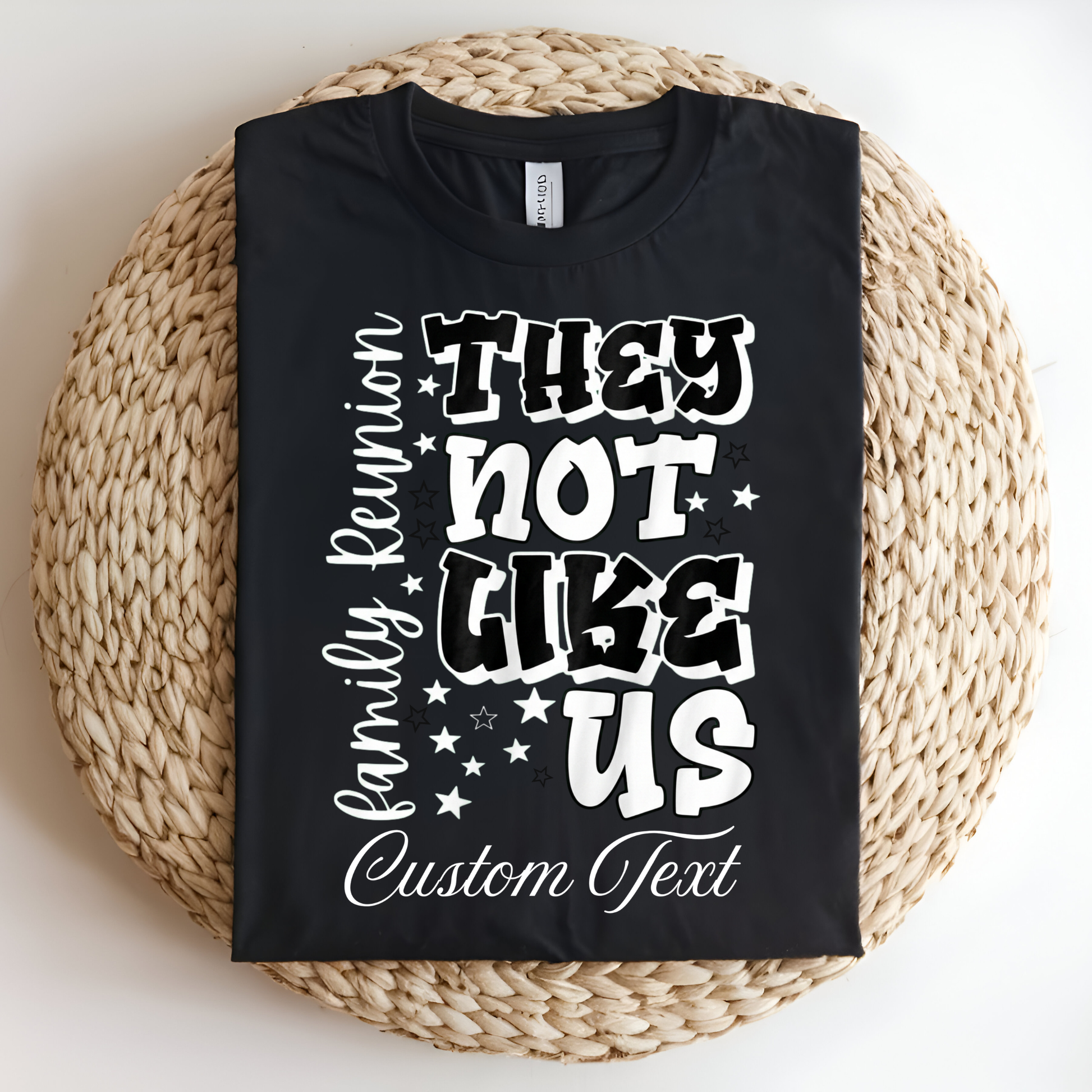 Black t-shirt with white text on a woven mat
