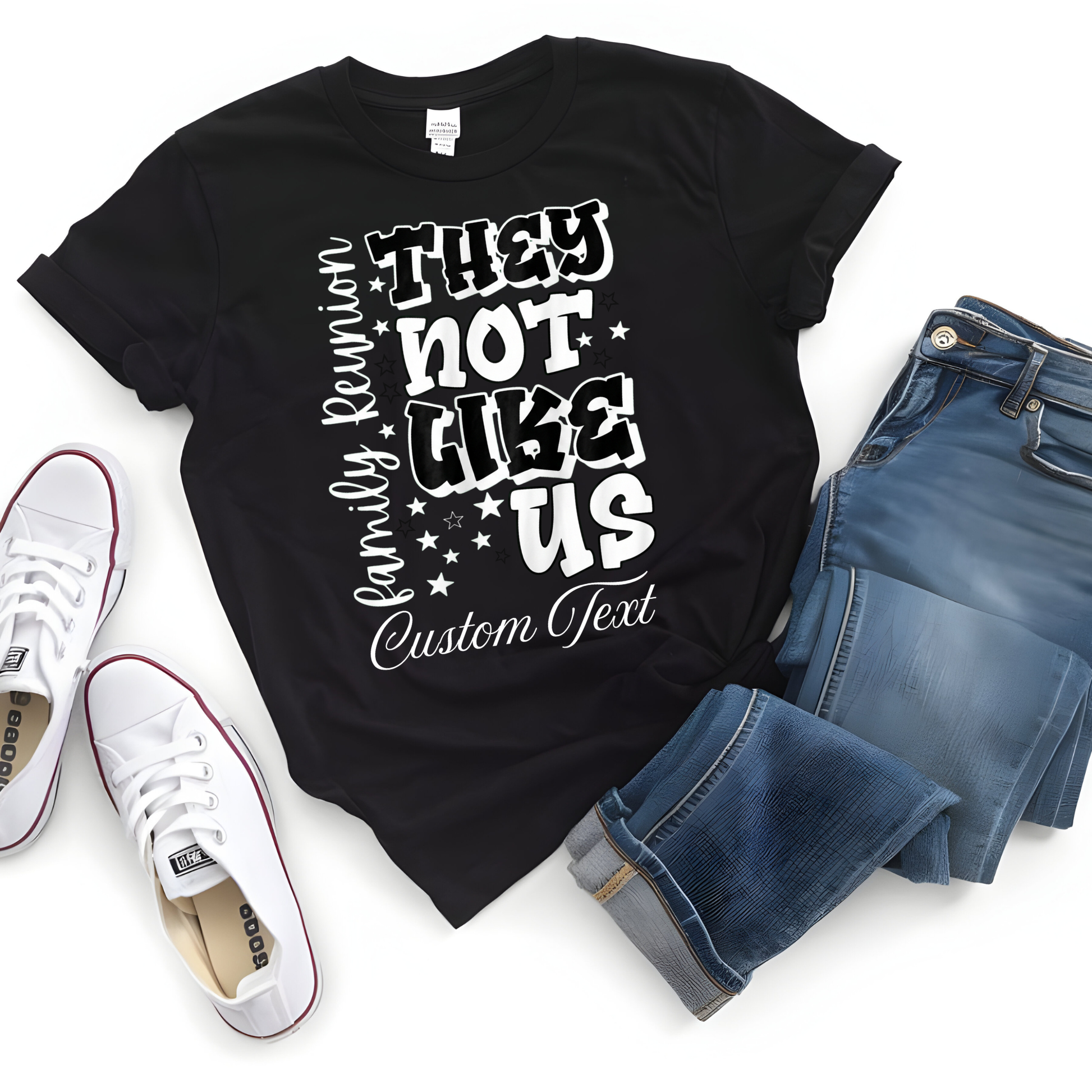 Black t-shirt with white text, blue jeans, and white sneakers on a white background