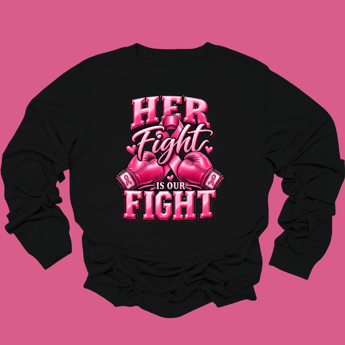A black long-sleeve t-shirt with a pink graphic print on the front that reads 'HER Fight IS OUR FIGHT' with boxing gloves, displayed against a solid pink background.