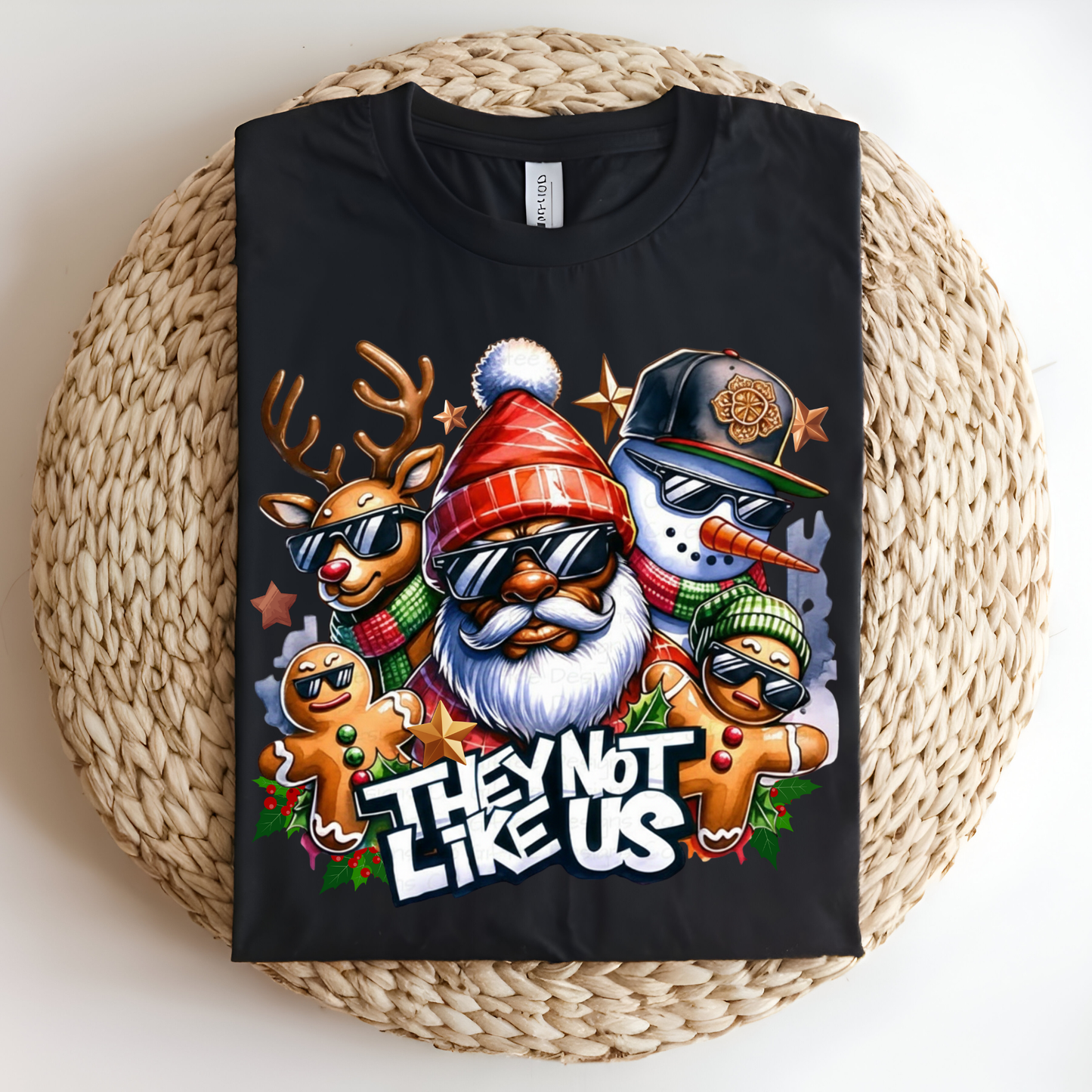 Black t-shirt with Christmas-themed design featuring a reindeer, gnome, snowman, and gingerbread man on a woven surface.