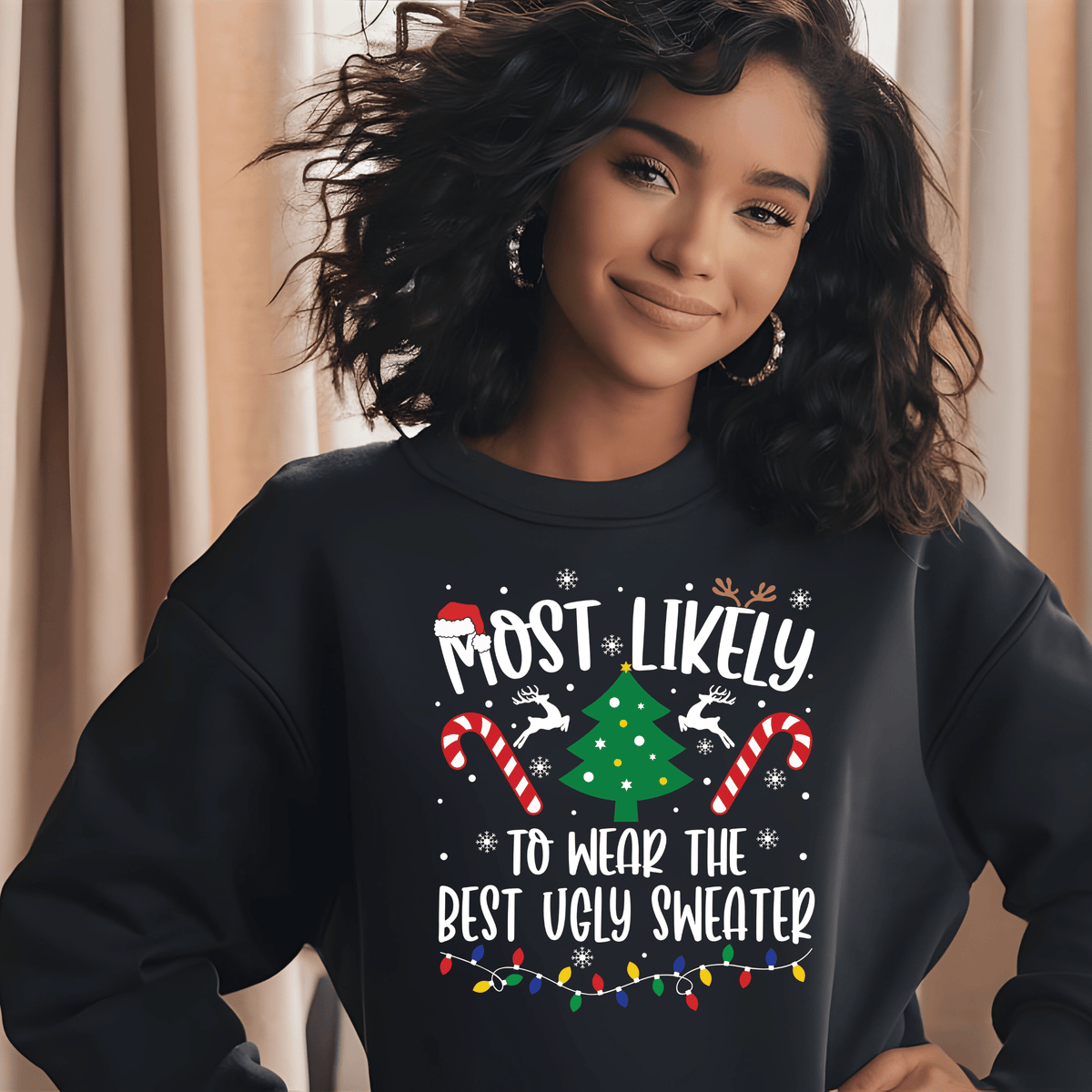 A woman wearing a black crewneck sweatshirt with a festive Christmas graphic that reads 'MOST LIKELY TO WEAR THE BEST UGLY SWEATER'. The graphic features a green Christmas tree, candy canes, reindeer, and colorful holiday lights.