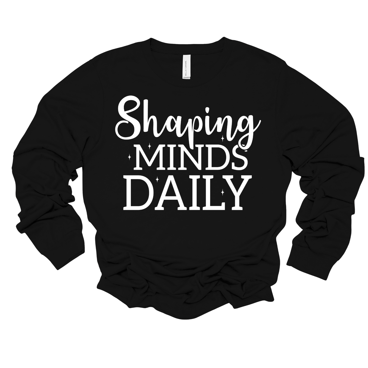 A black long-sleeve t-shirt with the phrase 'Shaping MINDS DAILY' printed in white across the chest, shown on a plain white background.