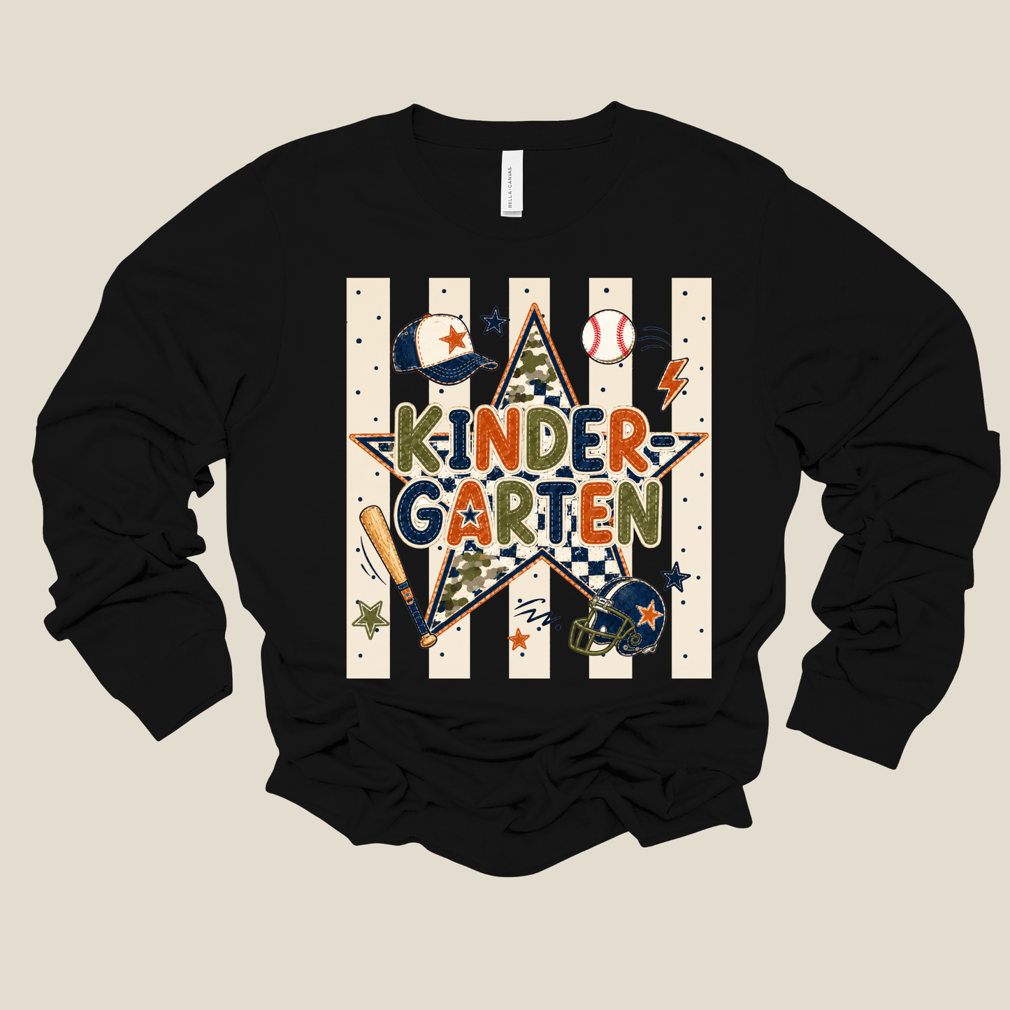 A black long-sleeve crewneck sweatshirt with a colorful 'Kinder Garten' baseball-themed graphic on the front, displayed against a solid light beige background.