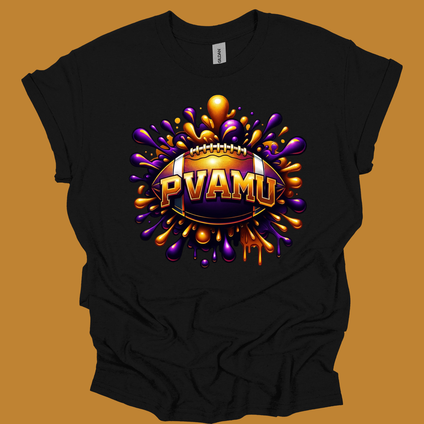 A black short-sleeve t-shirt with a large graphic print on the front. The graphic features a football surrounded by purple and gold paint splatters, with the text 'PVAMU' in gold 3D lettering.
