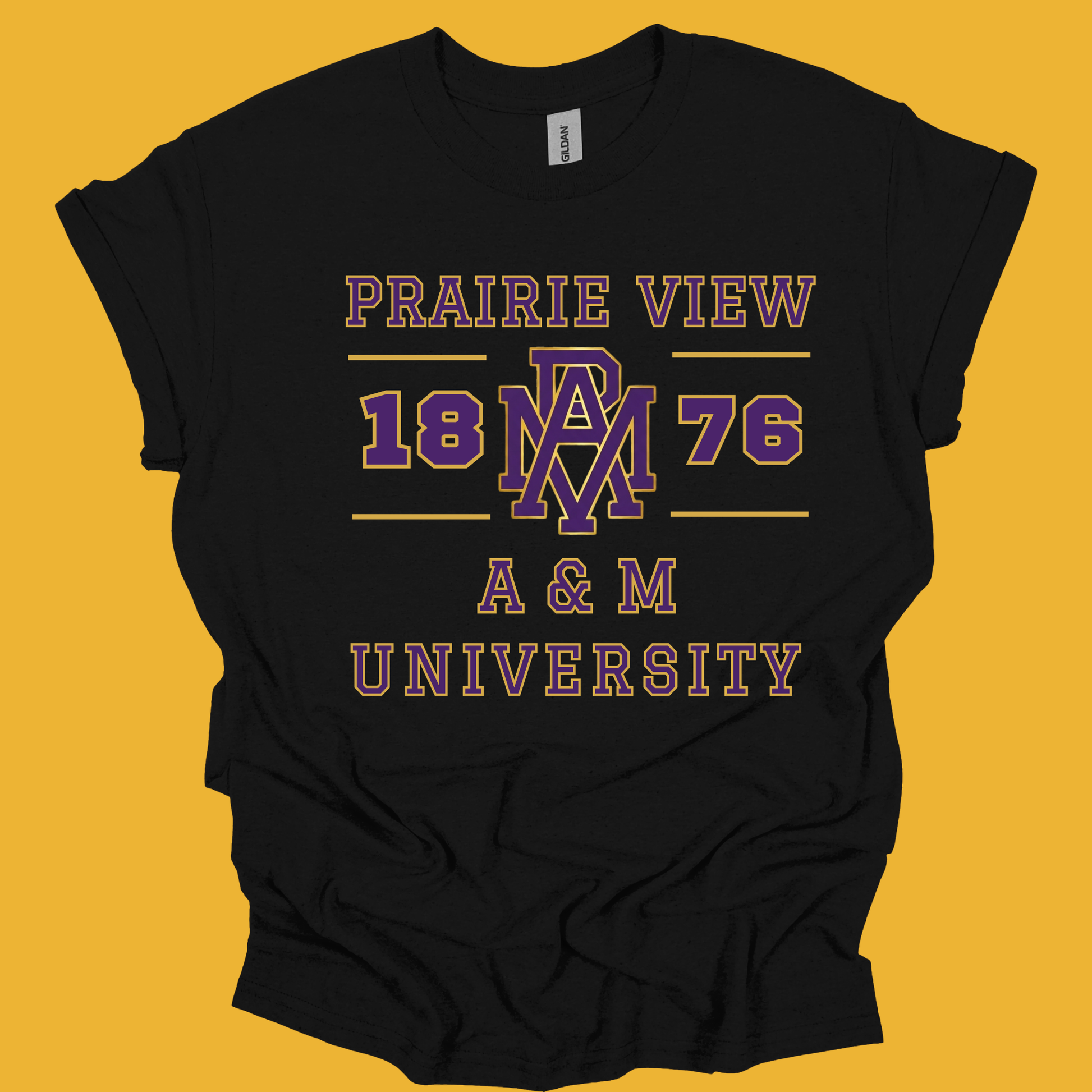 A black short-sleeve t-shirt with a vintage-style collegiate graphic reading 'PRAIRIE VIEW 1876 A & M UNIVERSITY' in purple and pink, laid flat against a solid mustard yellow background.