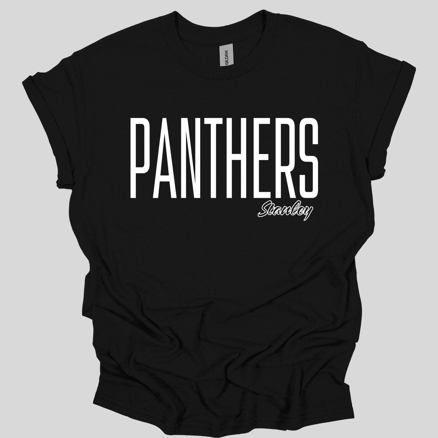 A black short-sleeve t-shirt with 'PANTHERS' printed in large white block letters across the chest and 'Stanley' in a smaller white script below it, shown on a solid gray background.