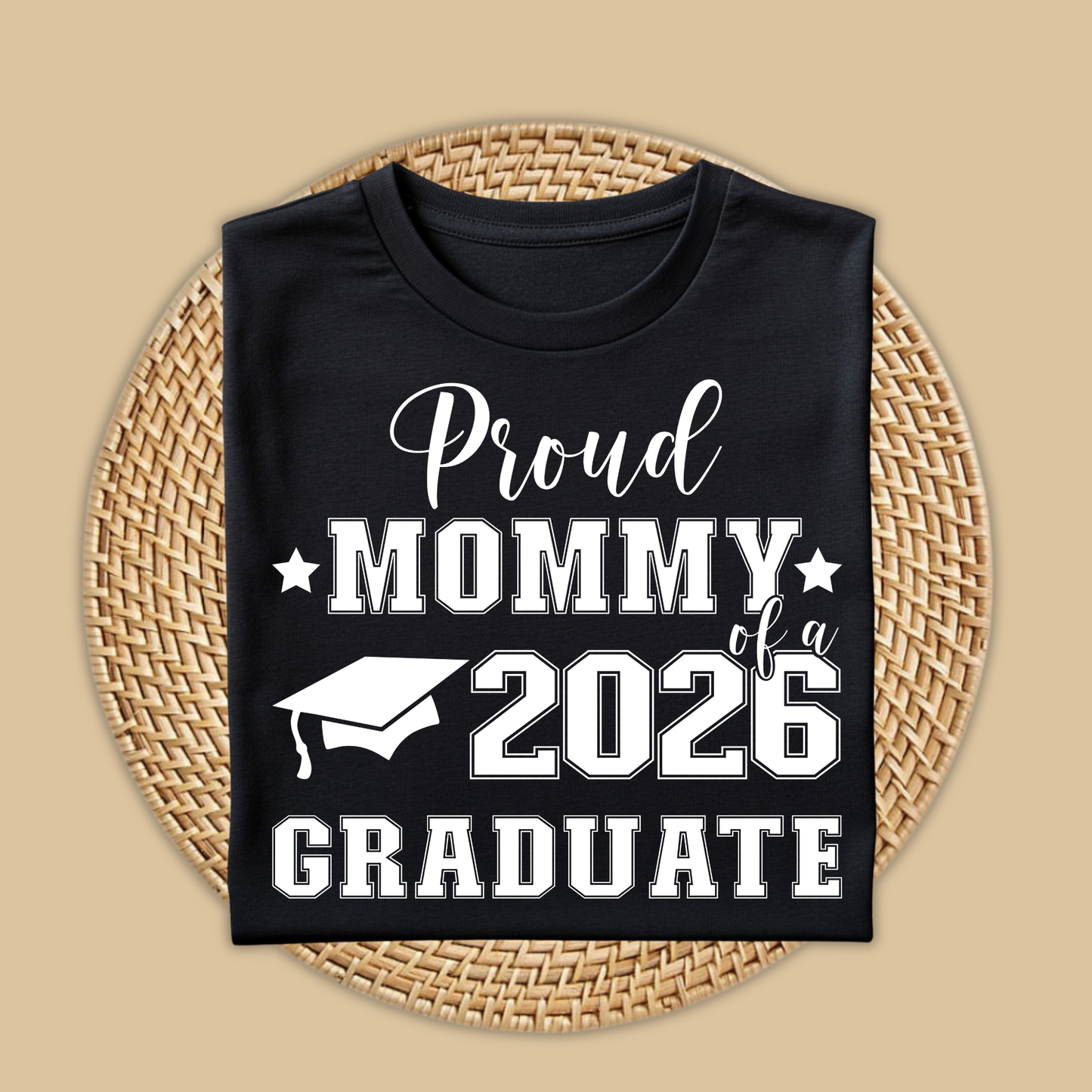 Black t-shirt with 'Proud Mommy of a 2026 Graduate' text on a woven mat.  Proud Family Graduate Tee - Senior Class of 2026 Proud Family Senior Shirt