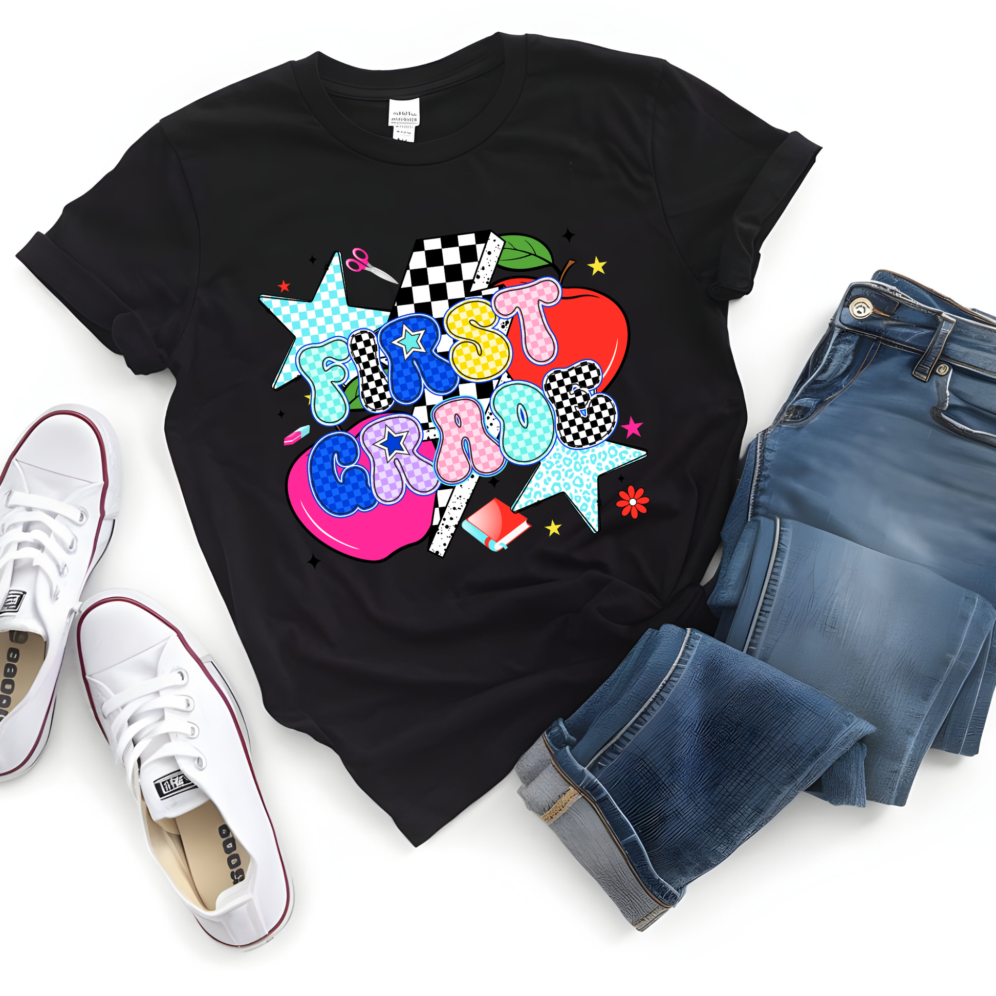 A black short-sleeve graphic T-shirt laid flat on a white background, styled with blue jeans and white low-top sneakers. The shirt features a colorful retro-style graphic with the word 'Crazy' in pastel letters and star shapes.