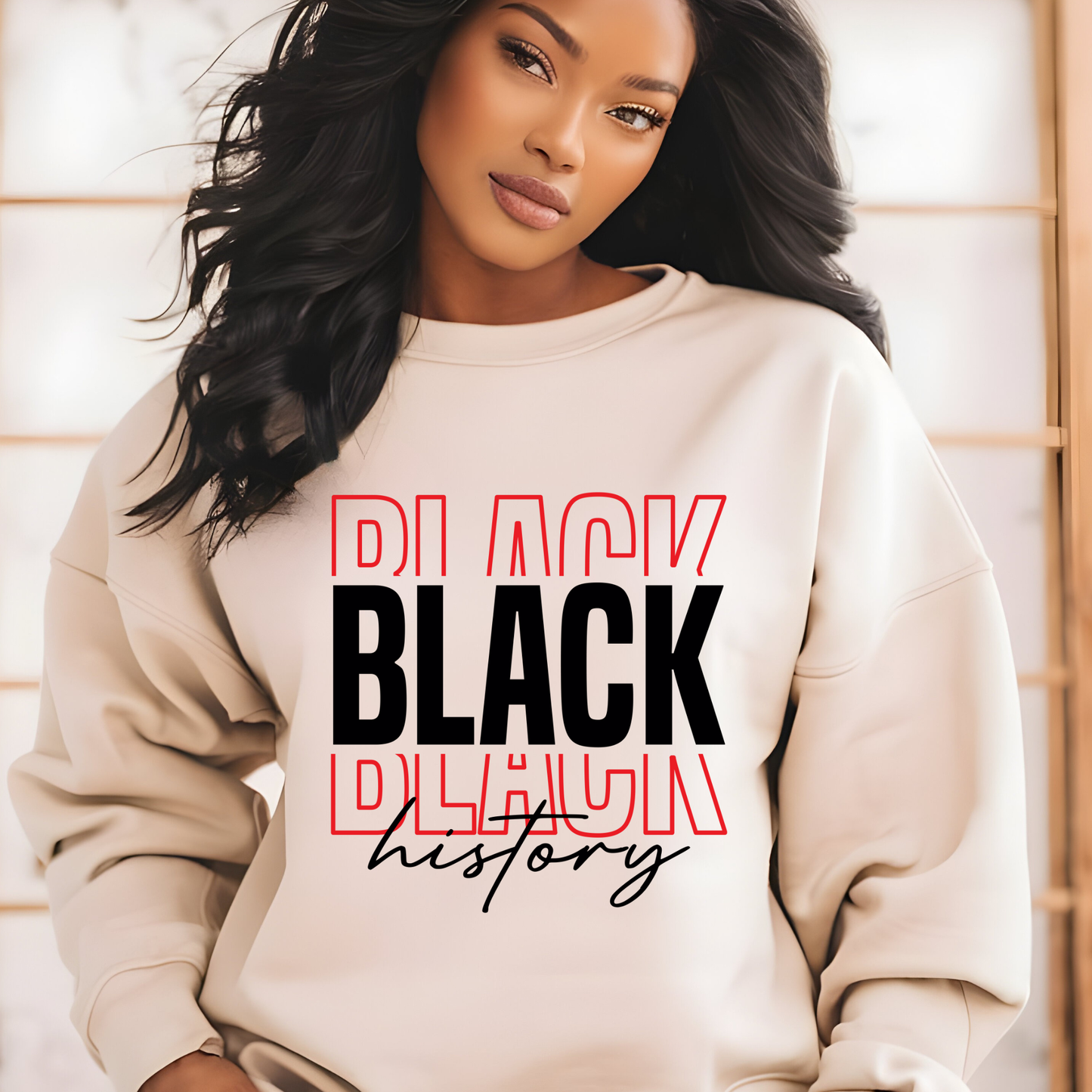 Woman wearing a beige sweatshirt with 'Black History' text design.