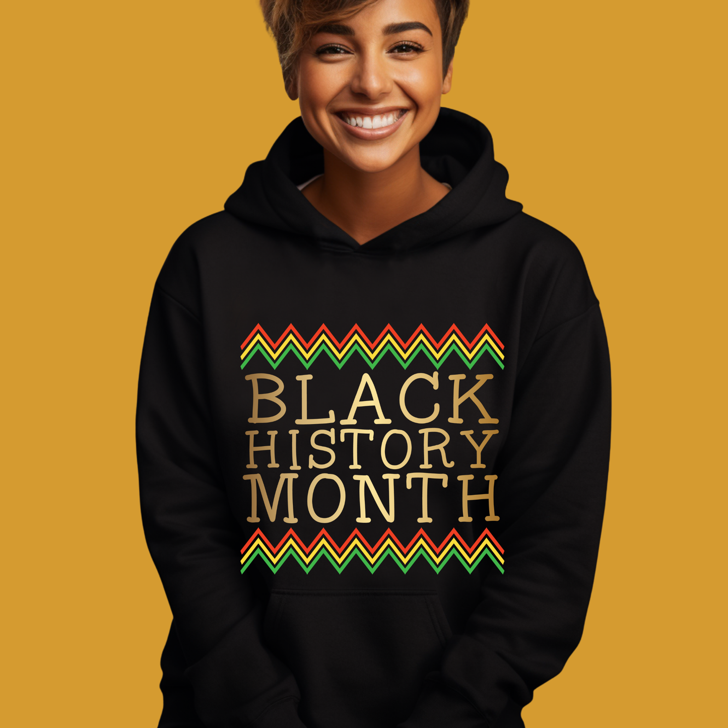 Person wearing a black hoodie with 'Black History Month' text on a mustard yellow background
