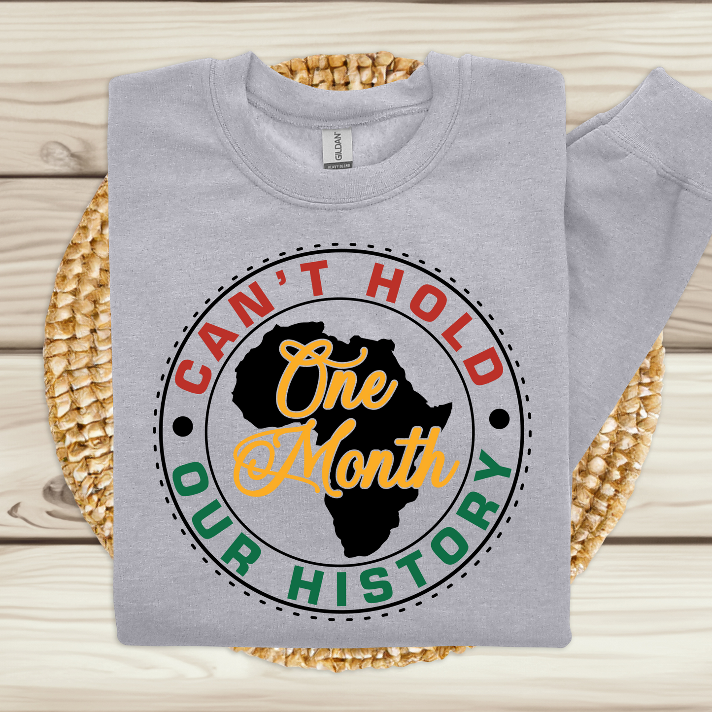 Black Women wearing white warm crewneck sweatshirt sweater with the phrase One Month Can't Hold our history in support of Black Culture and Black History Month Celebrations 