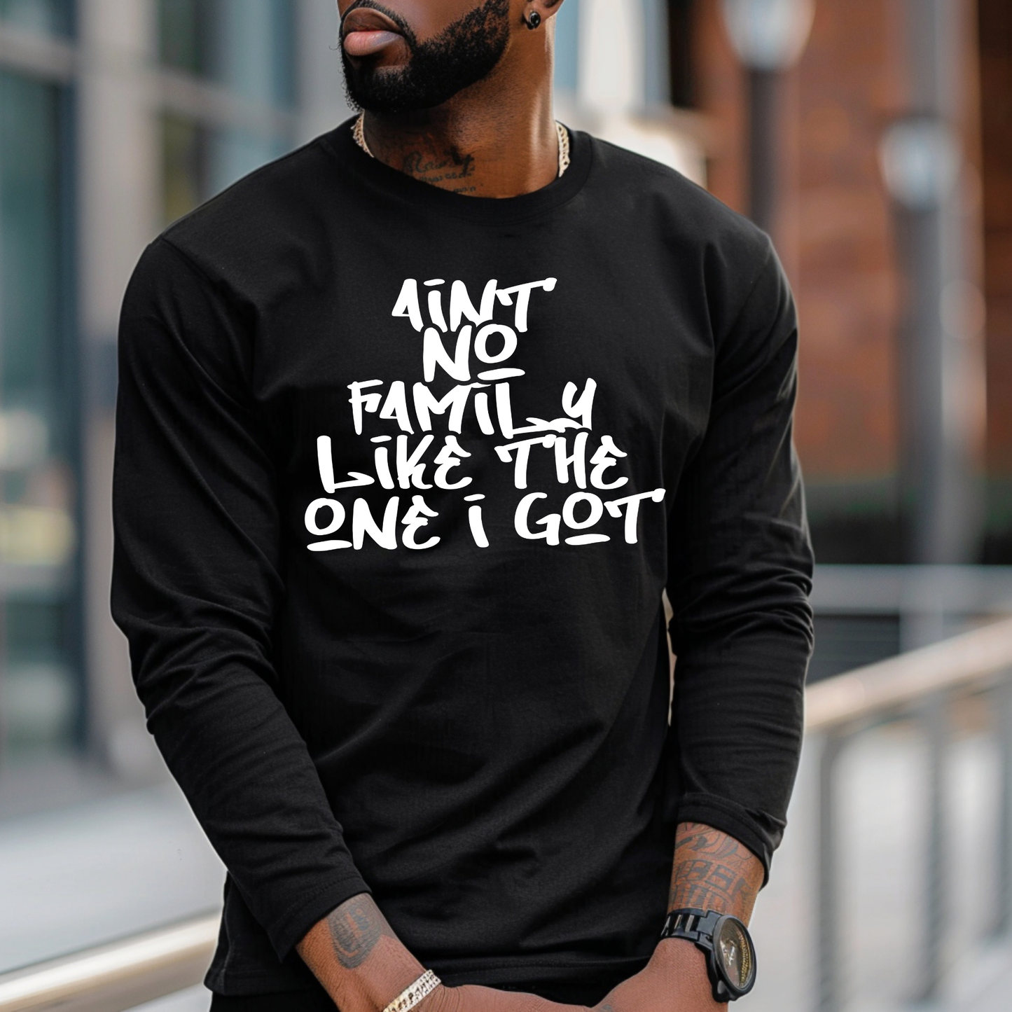 Person wearing a black long-sleeve shirt with white text outdoors.