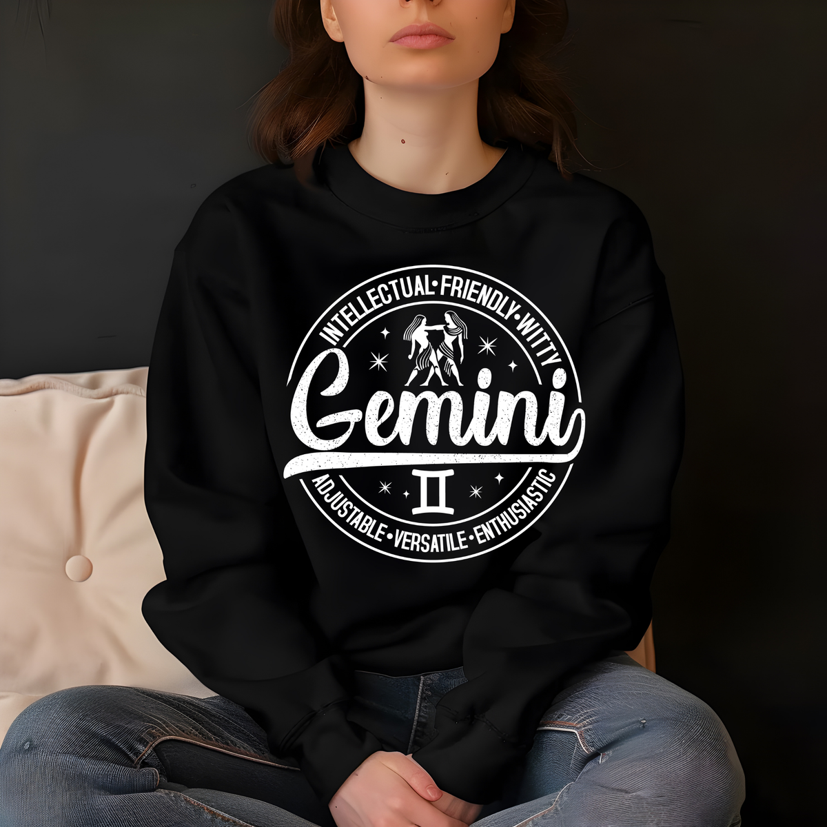black crewneck t-shirt laid flat, featuring a circular white Gemini zodiac graphic with the twins illustration, the word "Gemini," and trait keywords like intellectual, friendly, witty, enthusiastic, versatile, and adjustable.