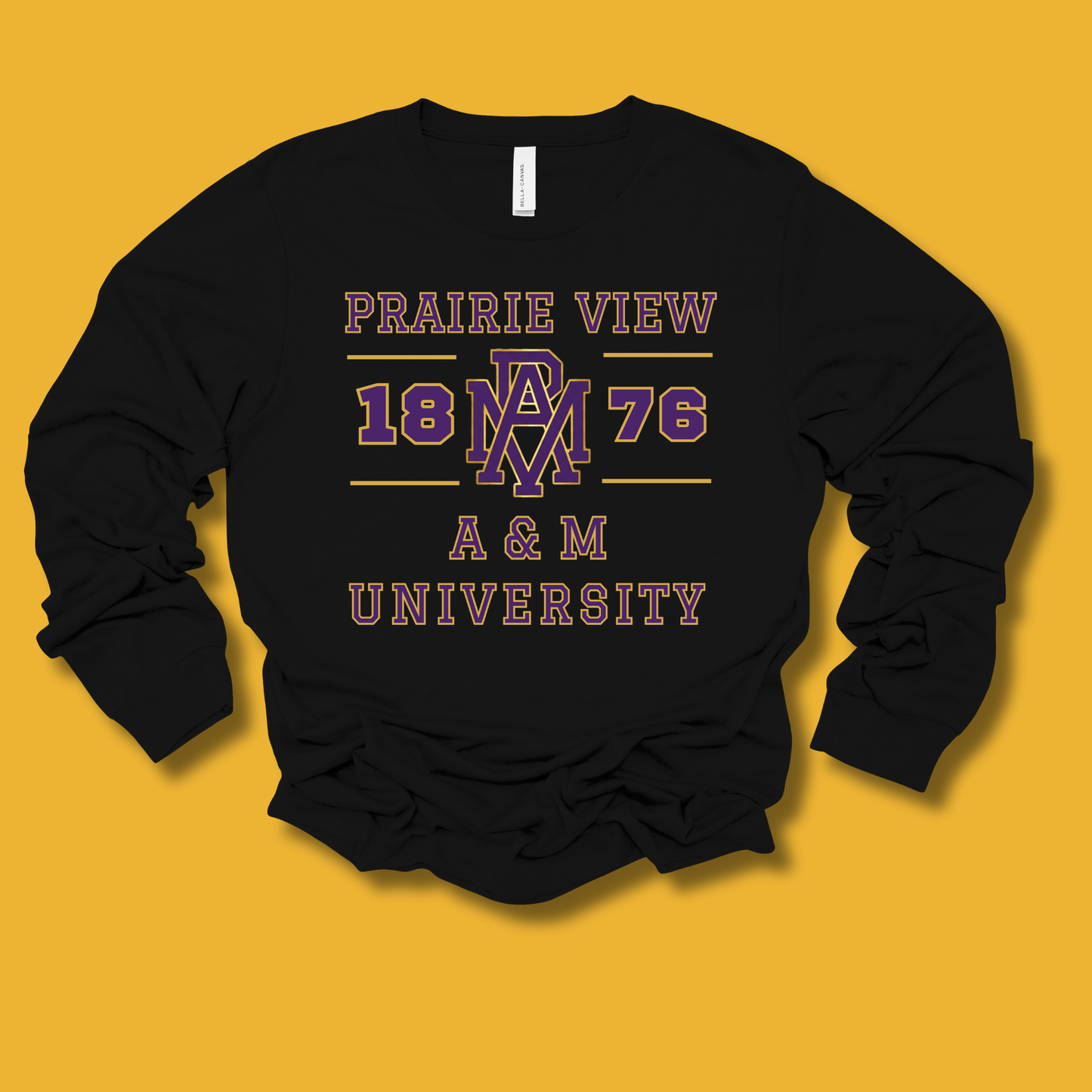 A black long-sleeve crewneck sweatshirt with a vintage-style collegiate graphic on the front reading 'PRAIRIE VIEW 1876 A & M UNIVERSITY' in purple and dusty pink, laid flat against a solid mustard yellow background.