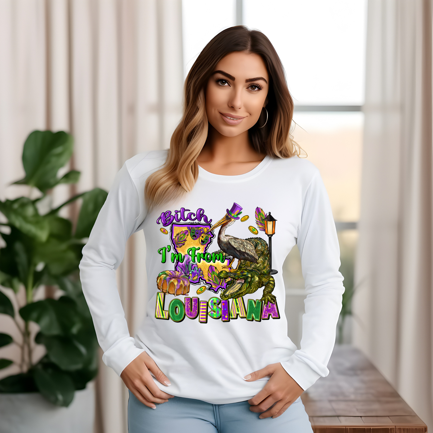 Woman wearing a white long-sleeve shirt with colorful graphics and text, standing indoors.