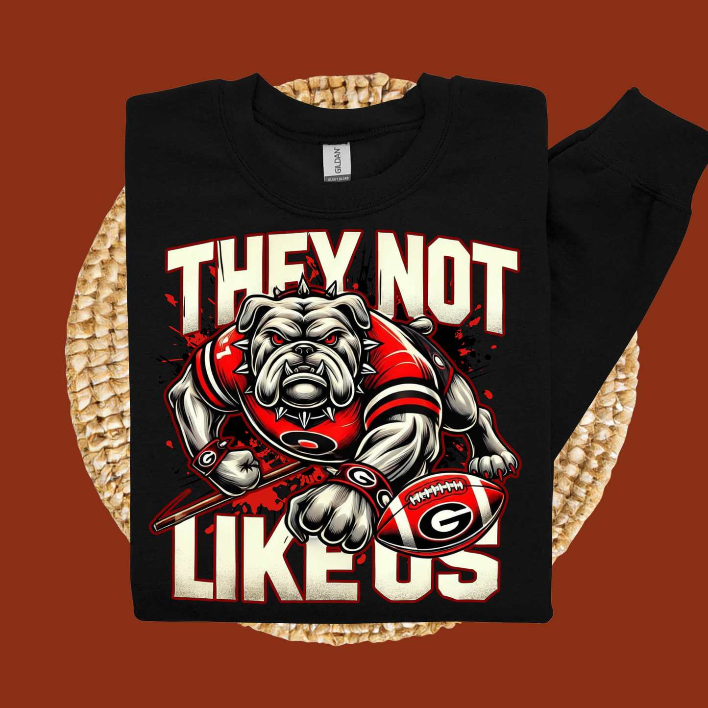 Black sweatshirt with bulldog graphic and text on a woven mat