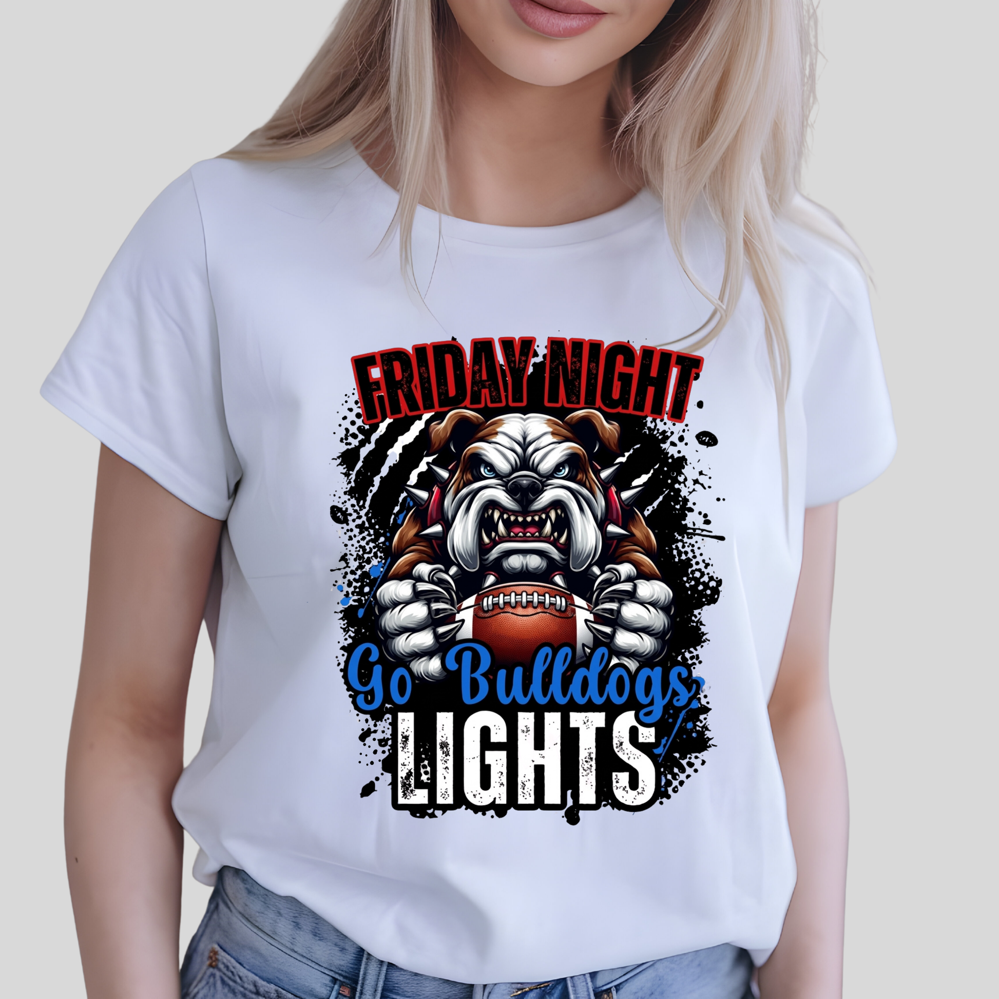 A woman wearing a white short-sleeve graphic T-shirt with a bulldog football graphic and the text 'FRIDAY NIGHT Go Bulldogs LIGHTS'.