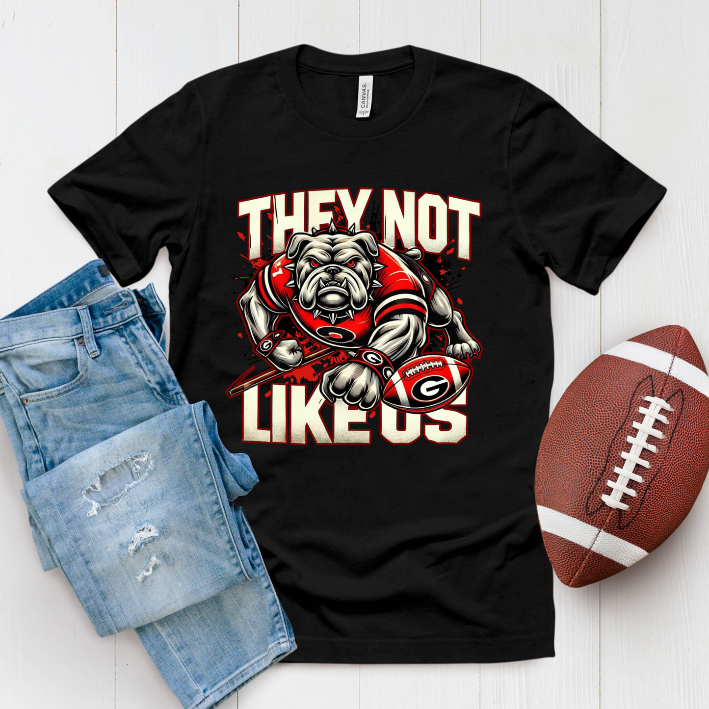 Black t-shirt with bulldog graphic and text, paired with denim shorts and a football on a white background