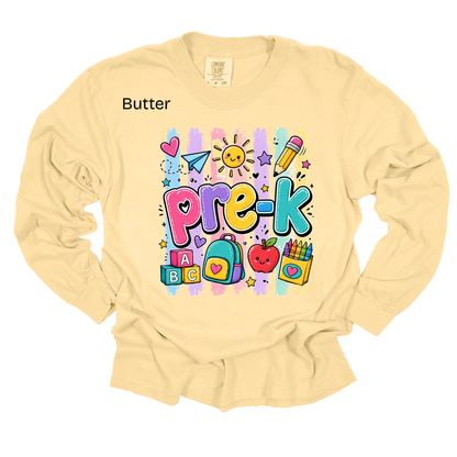 A pale butter-yellow long-sleeve t-shirt with a colorful 'Pre-K' cartoon graphic on the chest, featuring school-themed illustrations like pencils, a heart, and blocks. The word 'Butter' is printed in black near the left shoulder.
