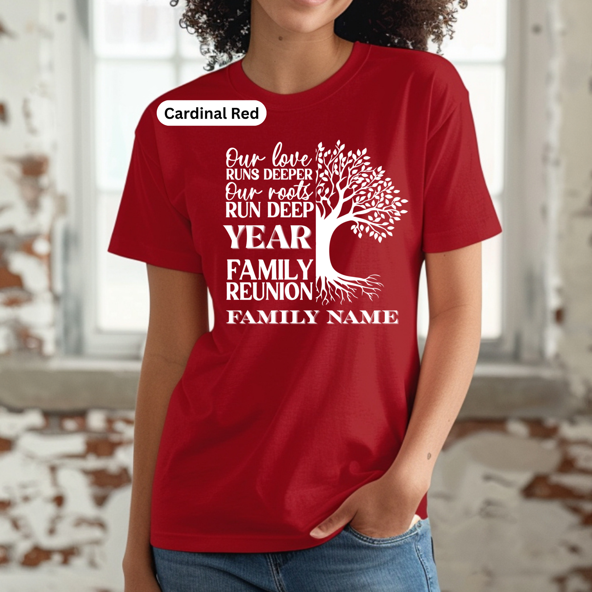 Red t-shirt with white text and tree design worn by a person indoors.