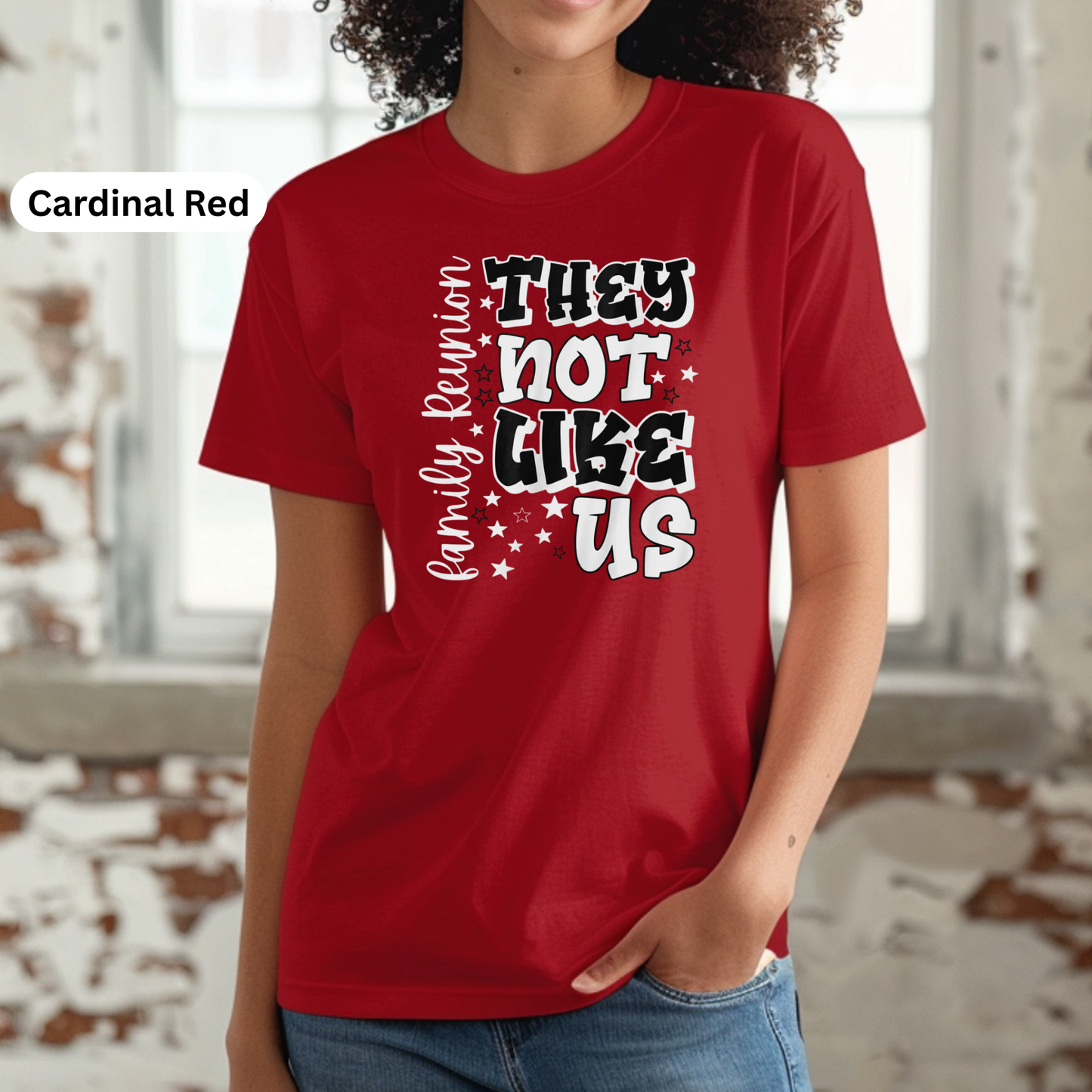 Person wearing a red t-shirt with text in a snowy outdoor setting