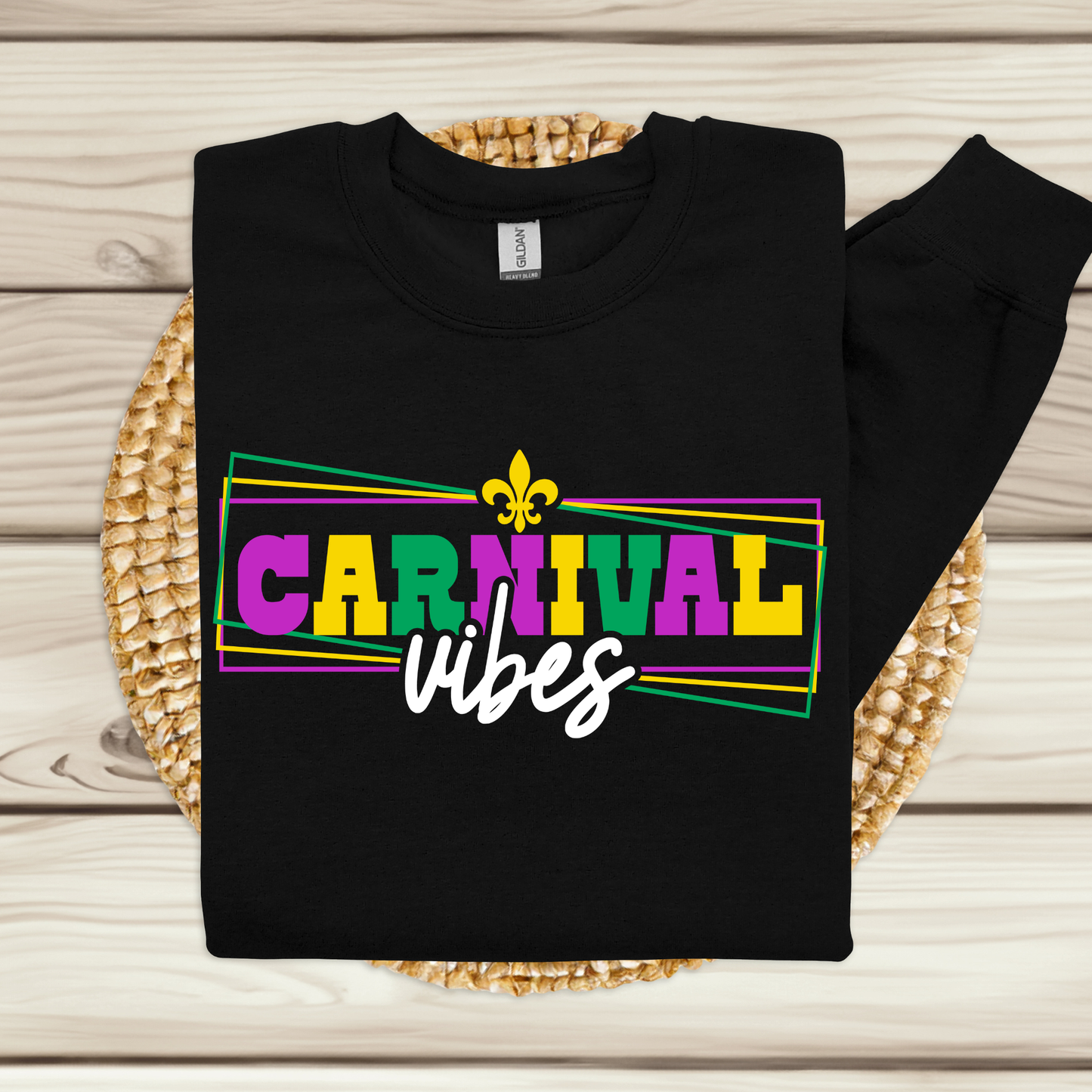 Black sweatshirt with 'Carnival vibes' text on a woven mat