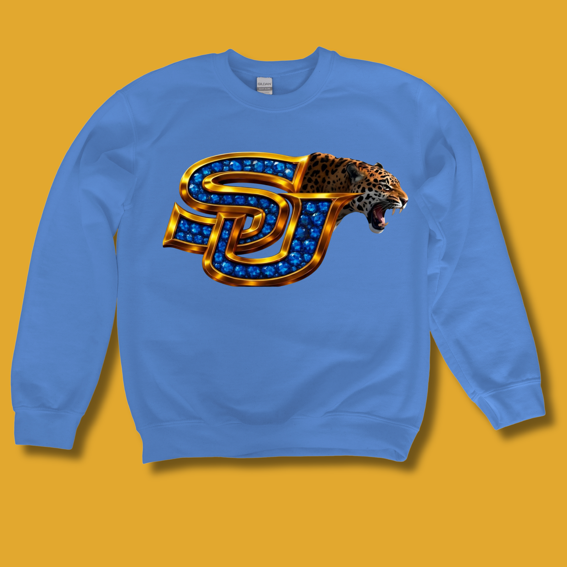 A light blue crewneck sweatshirt featuring a 'GAME DAY Vikings' graphic on the chest, displayed against a solid dark navy blue background.