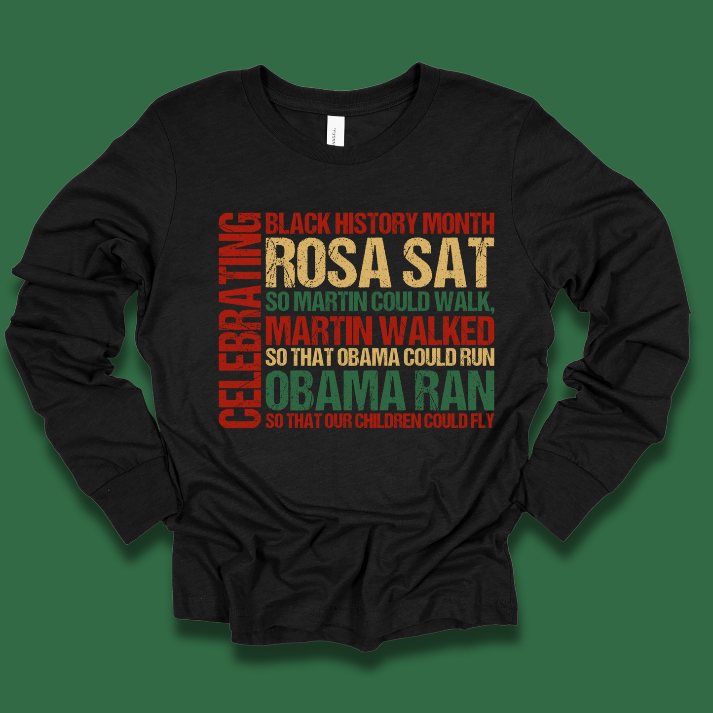 Black long-sleeve shirt with colorful text celebrating Black History Month on a green background