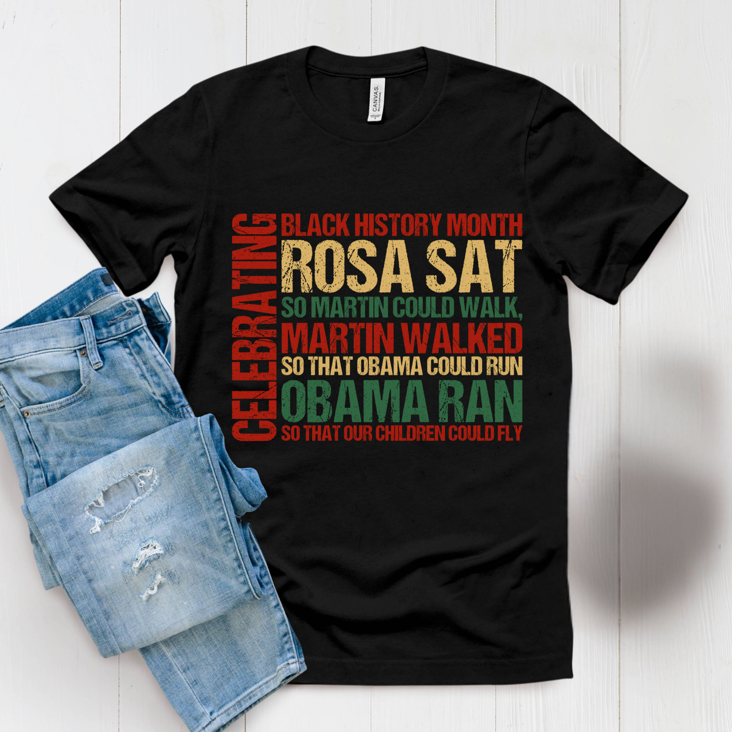 Black t-shirt with colorful text and denim shorts on a white background