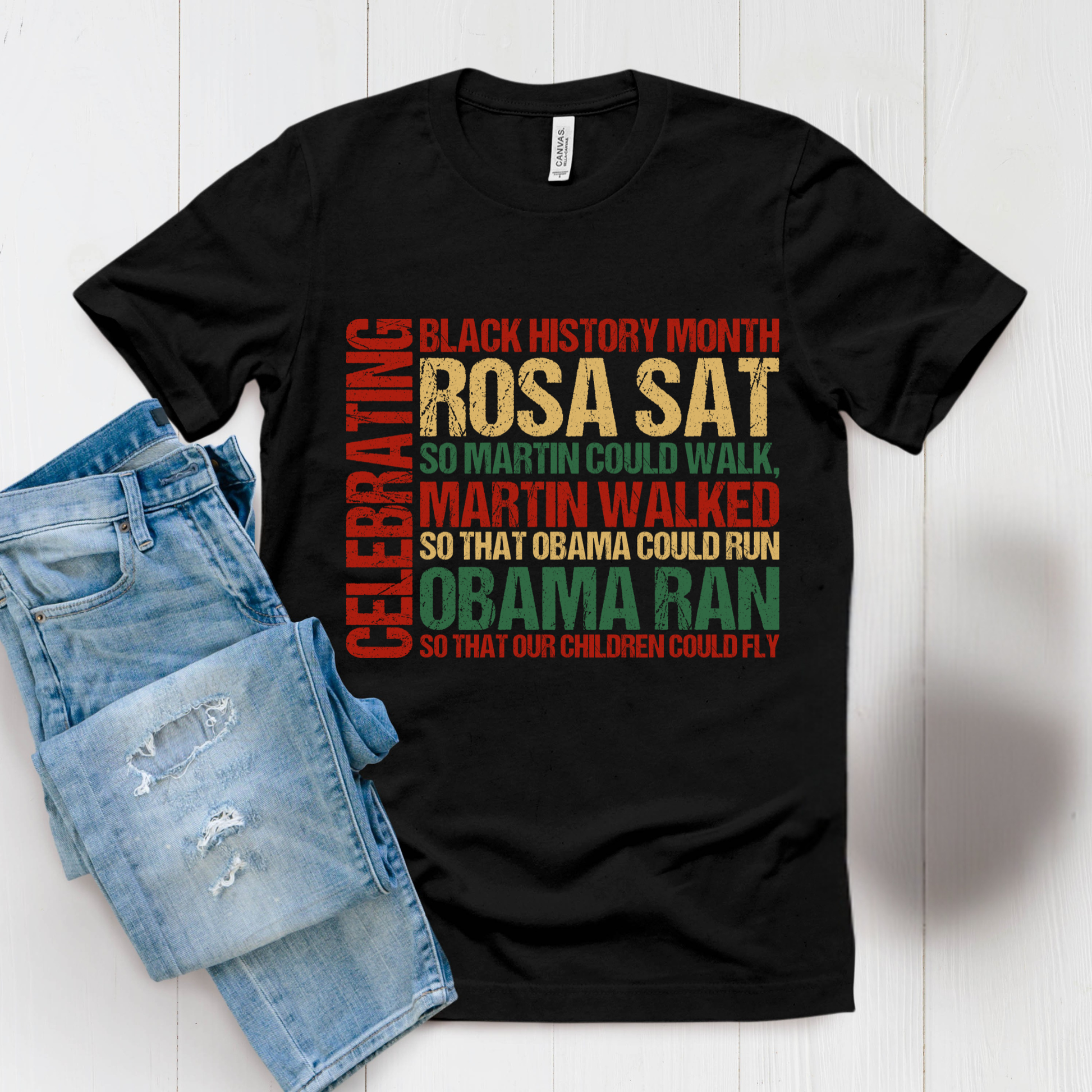 Black t-shirt with colorful text and denim shorts on a white background