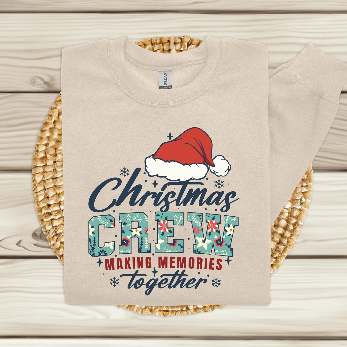 Beige sweatshirt with Christmas-themed design featuring a Santa hat on a woven mat.