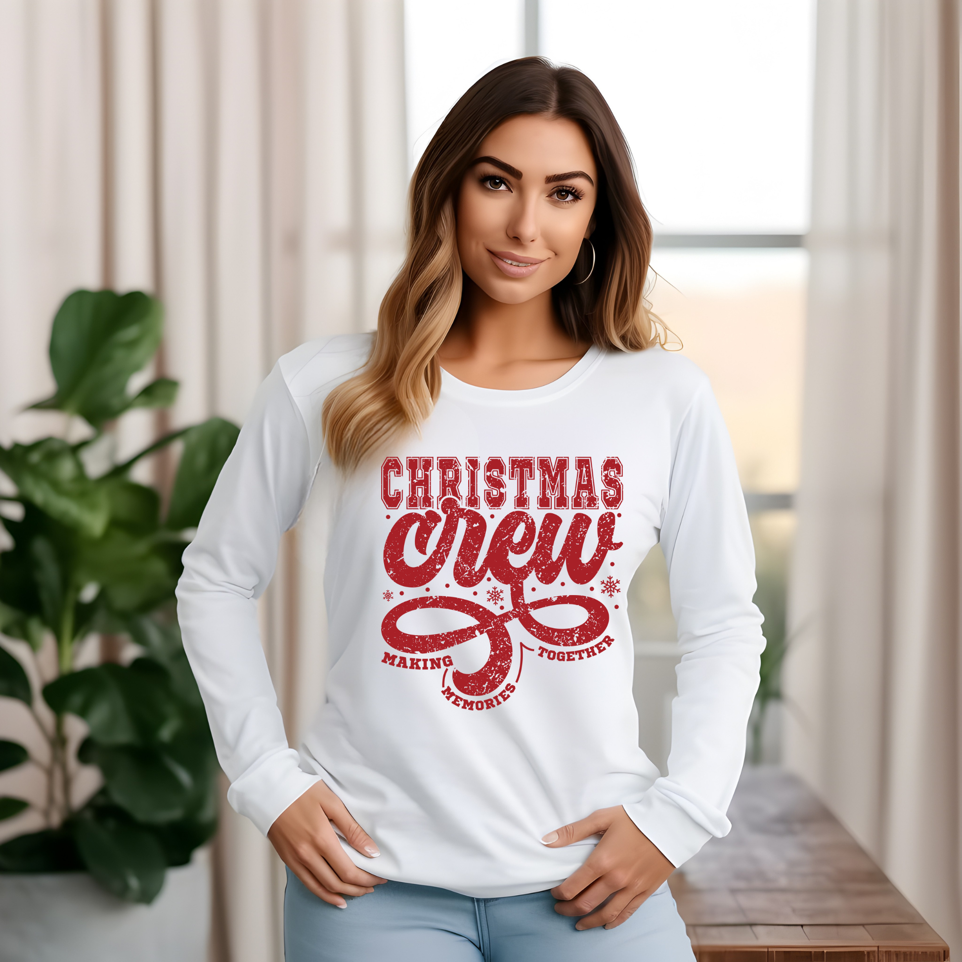 Woman wearing a white long-sleeve shirt with red 'Christmas Crew' text in a home setting.  Christmas Crew Making Memories Together T-Shirt - Family Matching Holiday Sweater