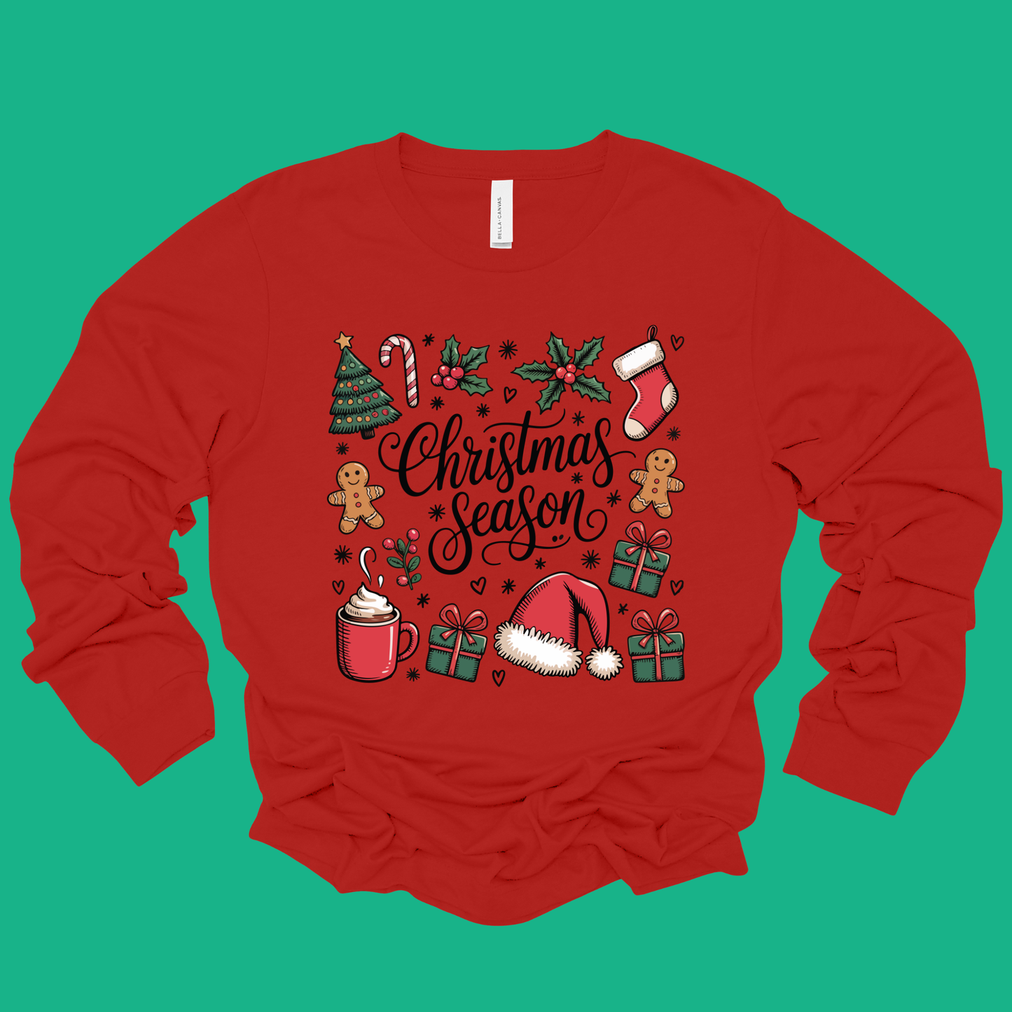 Red long-sleeve shirt with Christmas-themed graphics on a green background