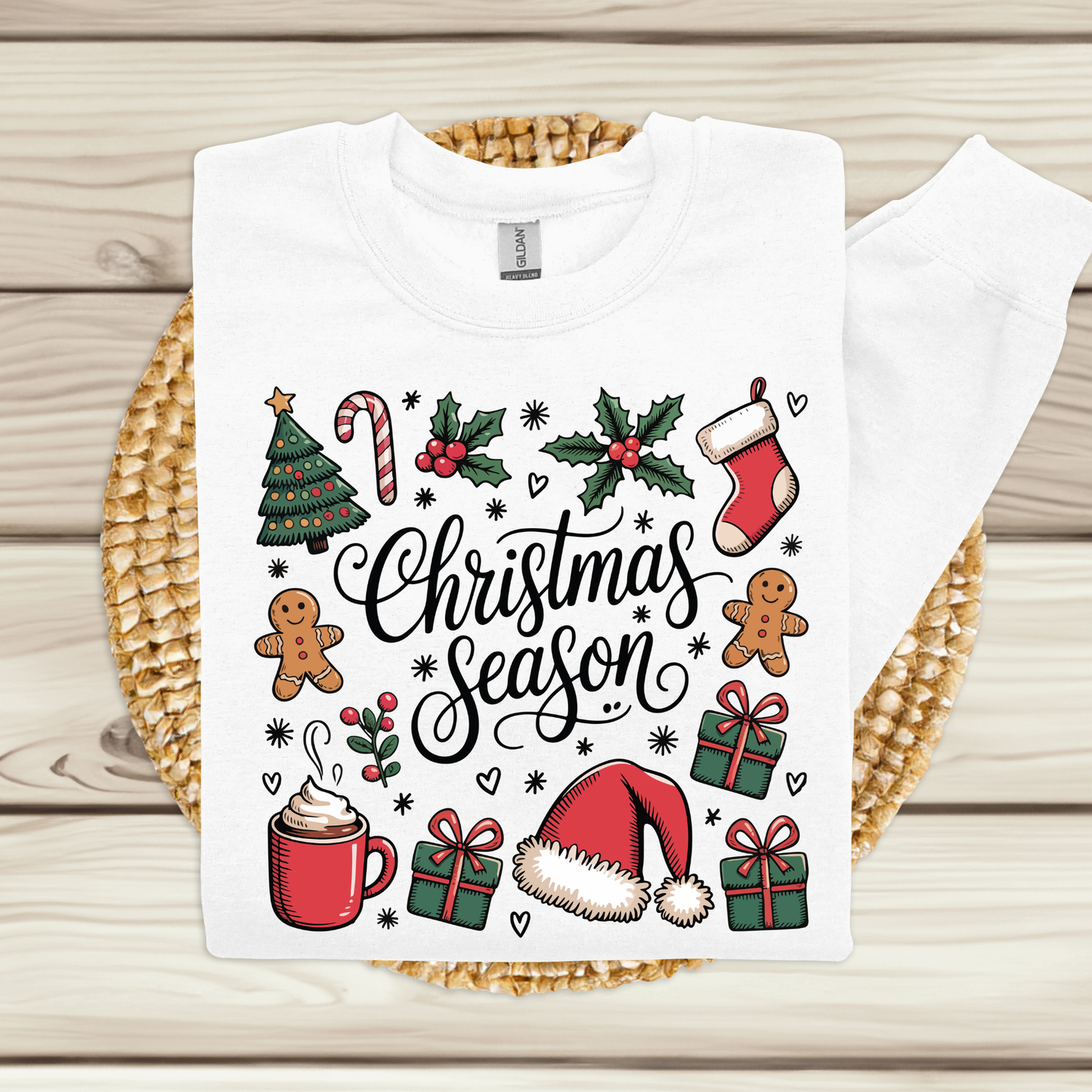 White t-shirt with Christmas-themed design on a wooden surface