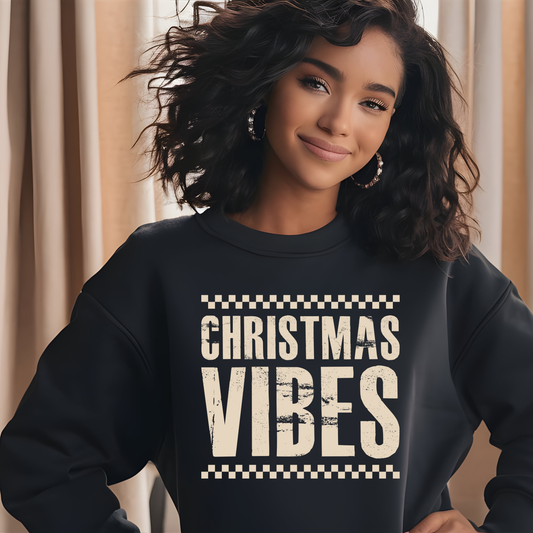 Person wearing a black sweatshirt with 'Christmas Vibes' text