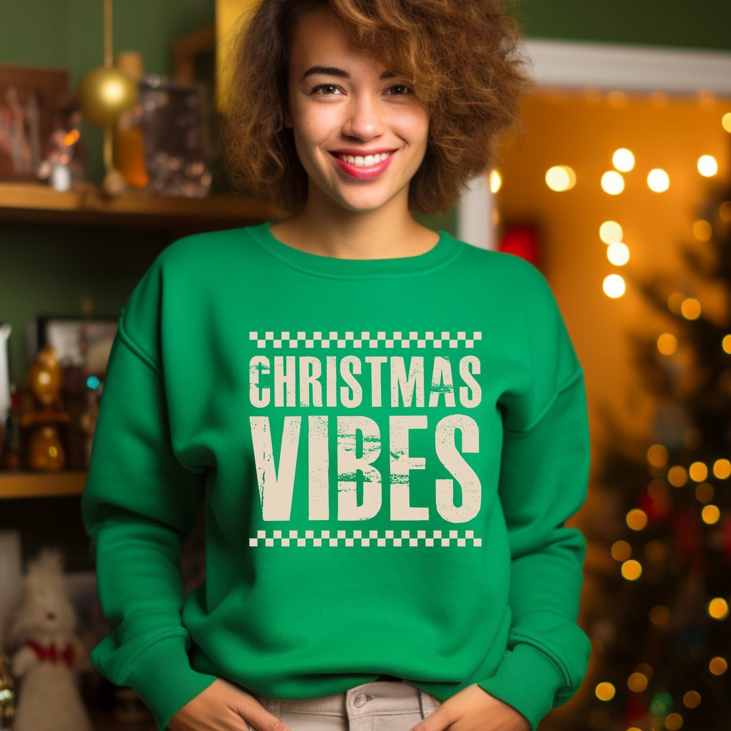 Person wearing a green 'Christmas Vibes' sweatshirt in a festive setting with lights and decorations.
