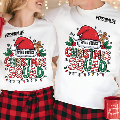 Two people wearing Christmas-themed t-shirts with festive designs and text.