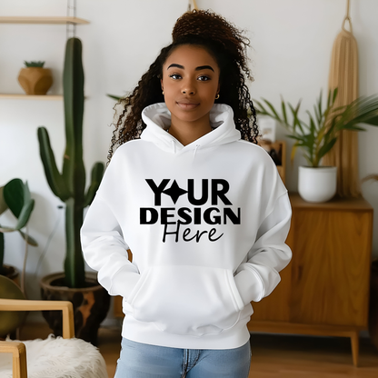 White hoodie with 'Your Design Here' text worn by a person in a room with plants.