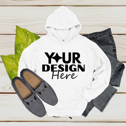 White hoodie with 'Your Design Here' text, gray loafers, and jeans on a wooden surface.