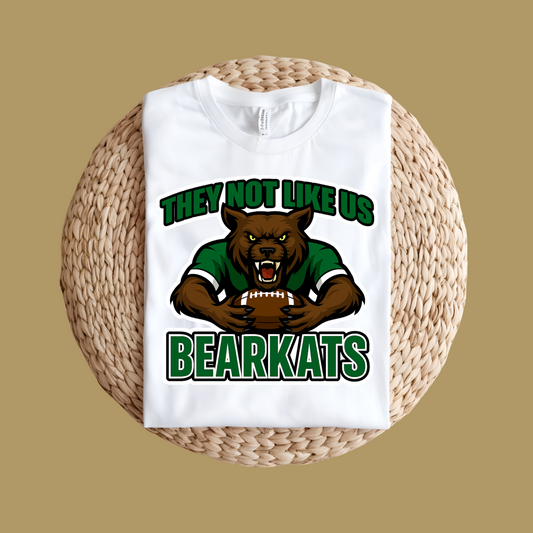 White t-shirt with bear graphic and text 'THEY NOT LIKE US BEARKATS' on a woven surface. Custom Mascot Shirt - BearKats They Not Like Us Game Day Spirit Tee